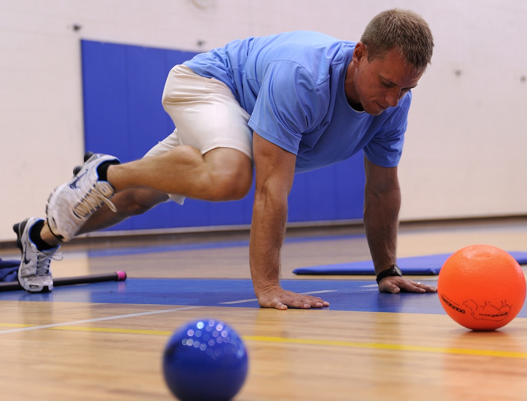 LANGLEY AIR FORCE BASE, Va. -- Chris Bendix, 633d Force Support Squadron fitness testing technician, demonstrates exercises designed to strengthen core muscles during the fitness assessment demonstration May 17. The demonstration is designed to prepare personnel for the transition to Fitness Assessment Cell testing in July. (U.S. Air Force Photo/Staff Sgt. Christina M. Styer) 