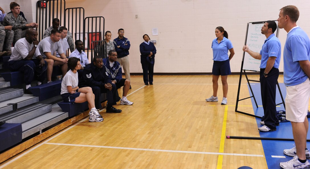 LANGLEY AIR FORCE BASE, Va. -- Tony Arroyo, Chris Bendix and 1st Lt. Krista Barajas, 633d Force Support Squadron fitness testing technicians, discuss proper form and training during the fitness assessment demonstration May 17. The demonstration is designed to prepare personnel for the transition to Fitness Assessment Cell testing in July. (U.S. Air Force Photo/Staff Sgt. Christina M. Styer) 