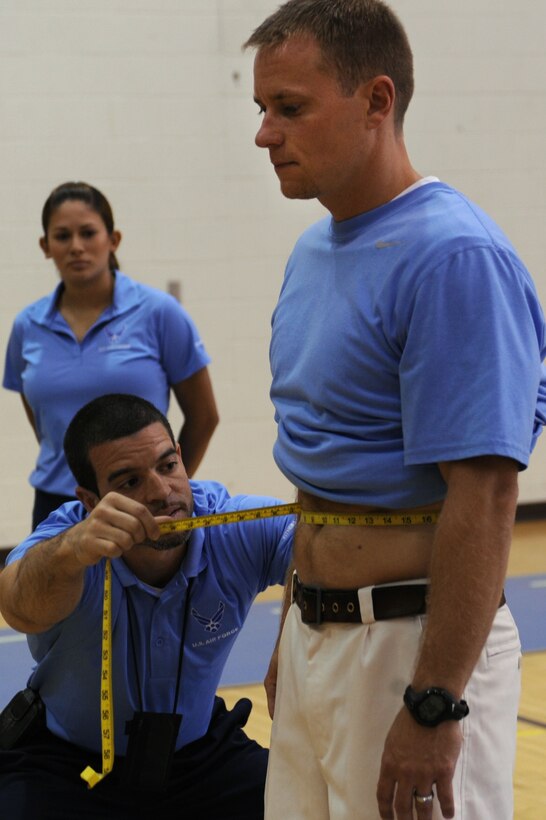LANGLEY AIR FORCE BASE, Va. -- Tony Arroyo, 633d Force Support Squadron fitness testing technician, demonstrates the proper abdominal taping using Chris Bendix, 633d Force Support Squadron fitness testing technician, as a model during the fitness assessment demonstration May 17. The demonstration is designed to prepare personnel for the transition to Fitness Assessment Cell testing in July. (U.S. Air Force Photo/Staff Sgt. Christina M. Styer) 