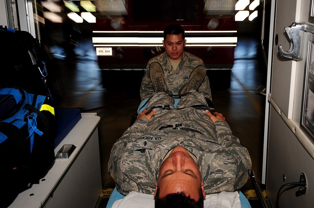 ELLSWORTH AIR FORCE BASE, S.D. - Senior Airman Clayton Luker, 28th Medical Operations Squadron aerospace medical technician, places a “patient” into an ambulance during readiness skills verification training, May 17. Members of the 28 MDOS train regularly to provide a fit and healthy force for global response. (U.S. Air Force photo/Airman 1st Class Joshua J. Seybert)