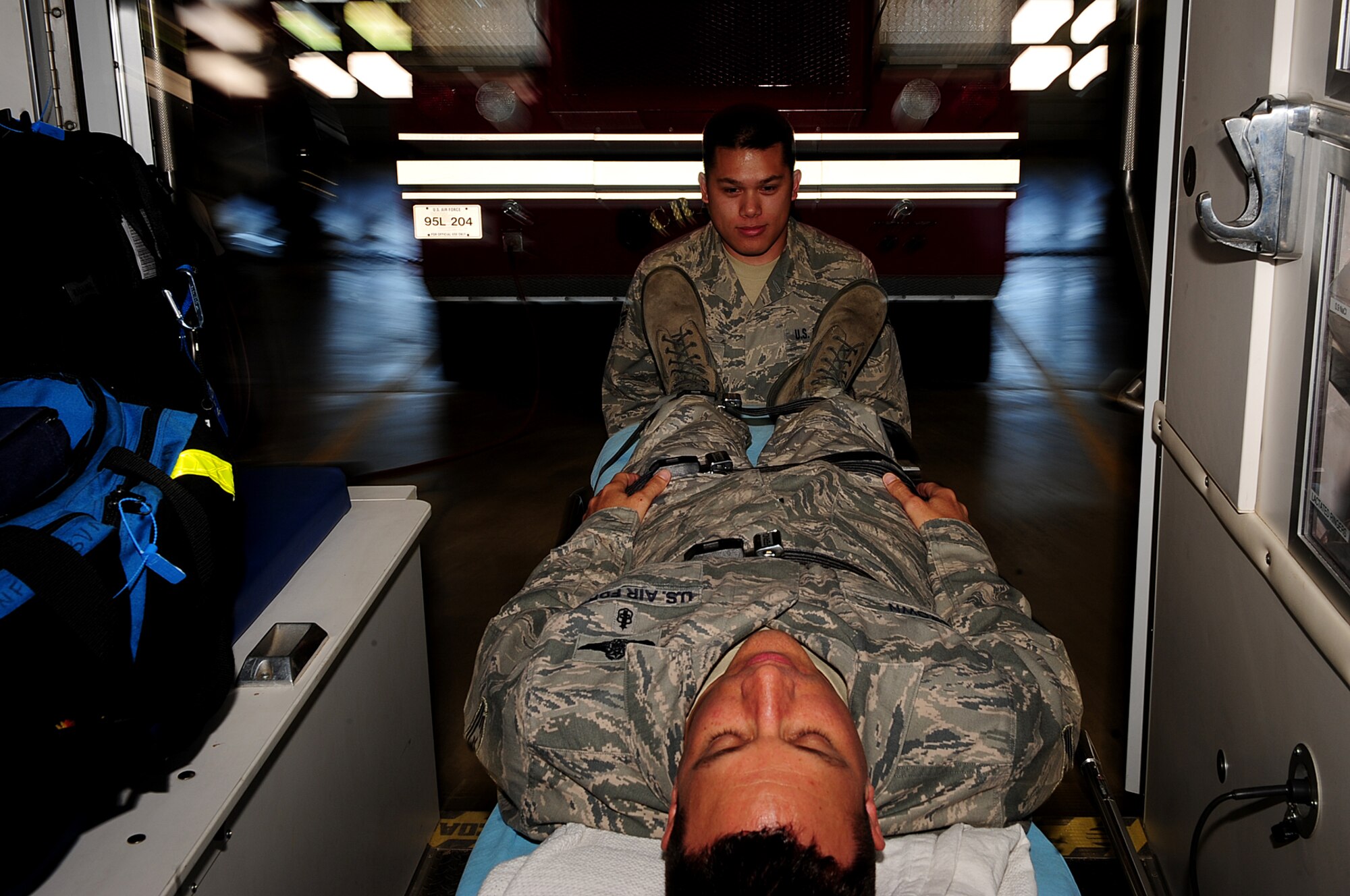 ELLSWORTH AIR FORCE BASE, S.D. - Senior Airman Clayton Luker, 28th Medical Operations Squadron aerospace medical technician, places a “patient” into an ambulance during readiness skills verification training, May 17. Members of the 28 MDOS train regularly to provide a fit and healthy force for global response. (U.S. Air Force photo/Airman 1st Class Joshua J. Seybert)