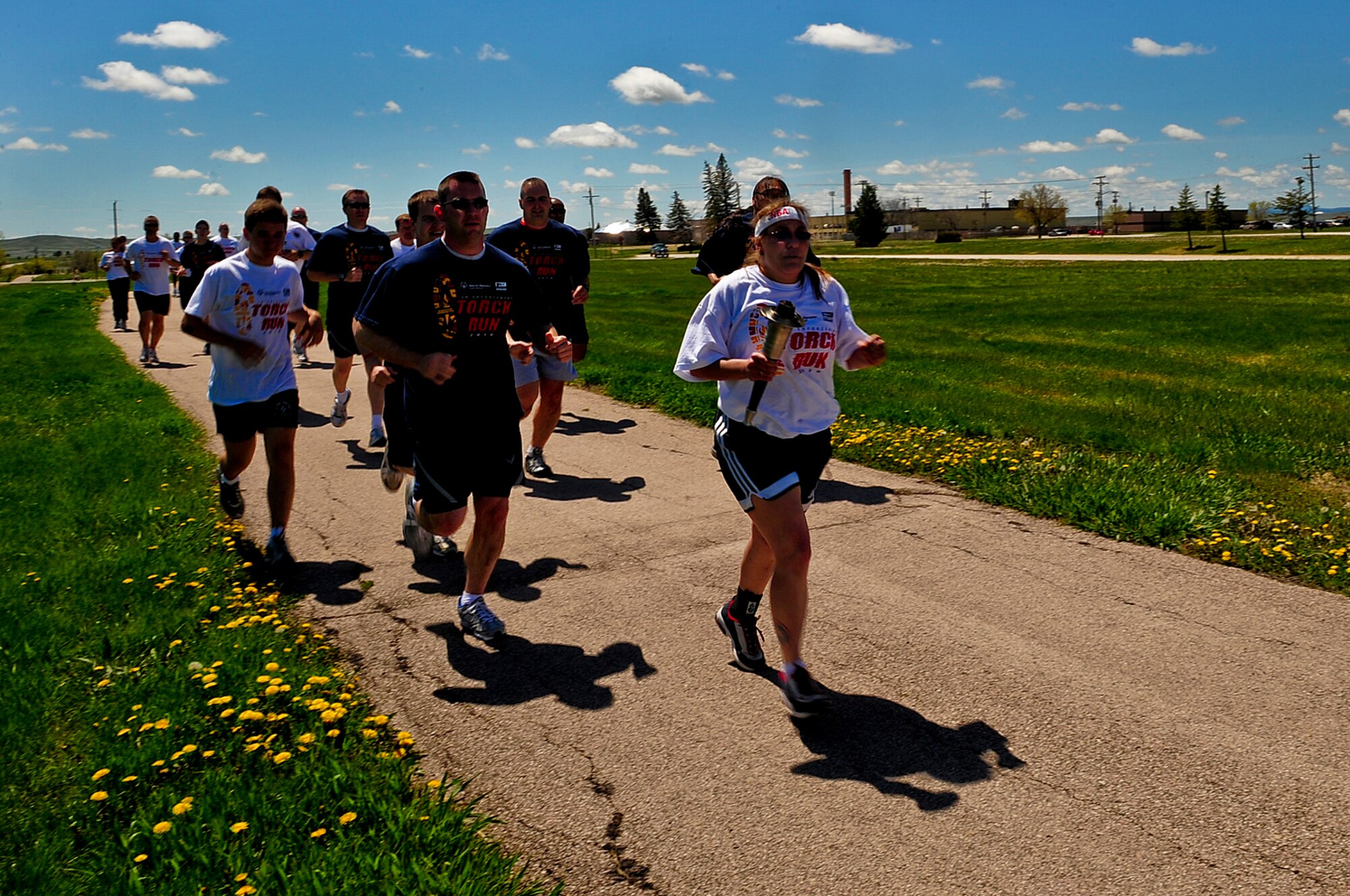ELLSWORTH AIR FORCE BASE, S.D. -- Members of the Air Force Office of Special Investigations, Detachment 226 and South Dakota law enforcement run with athletes from the South Dakota Special Olympics during the Law Enforcement Torch Run, May 17. Every state in the U.S.  has a Law Enforcement Torch Run to kick off their individual Special Olympics games. (U.S. Air Force photo/Airman 1st Class Joshua J. Seybert)