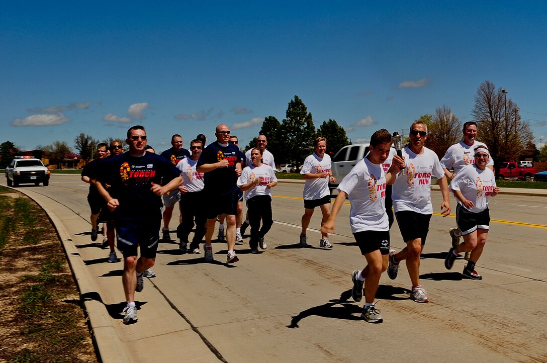 ELLSWORTH AIR FORCE BASE, S.D. -- Members of the Air Force Office of Special Investigations, Detachment 226 and South Dakota law enforcement run with athletes from the South Dakota Special Olympics during the Law Enforcement Torch Run, May 17. The run was started in 1981 to help raise money and awareness for the Special Olympics. (U.S. Air Force photo/Airman 1st Class Joshua J. Seybert)