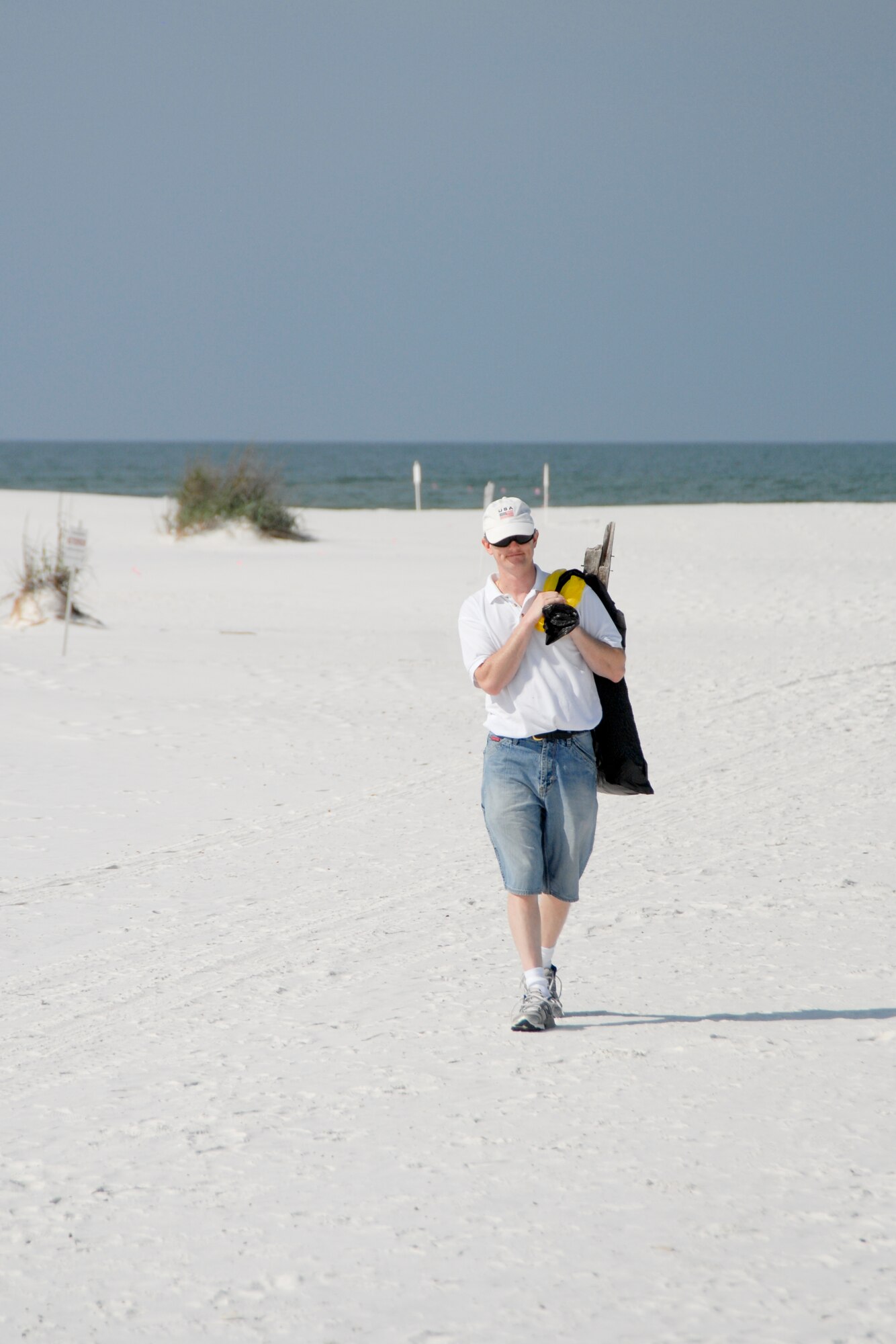 Master Sgt. Edward Quinn, Air Force Civil Engineer Support Agency operations management career field manager, helps in efforts to clean Tyndall beaches May 15.(U.S. Air Force photo by Susan Trahan)