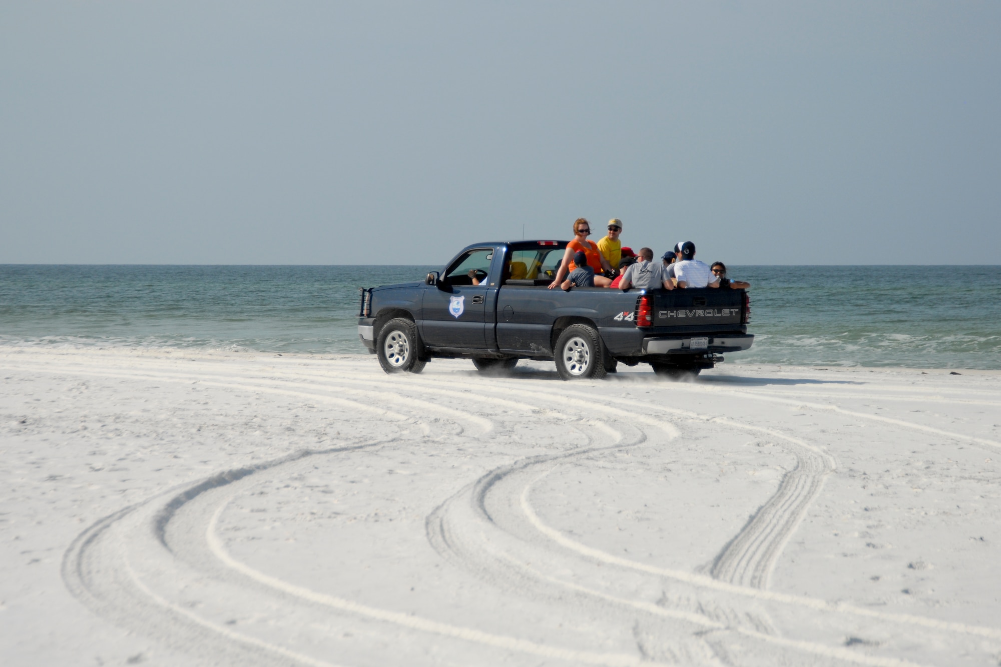Members of Tyndall Air Force Base load up in trucks to clean trash off of the base beaches May 15. (U.S. Air Force photo by Susan Trahan)