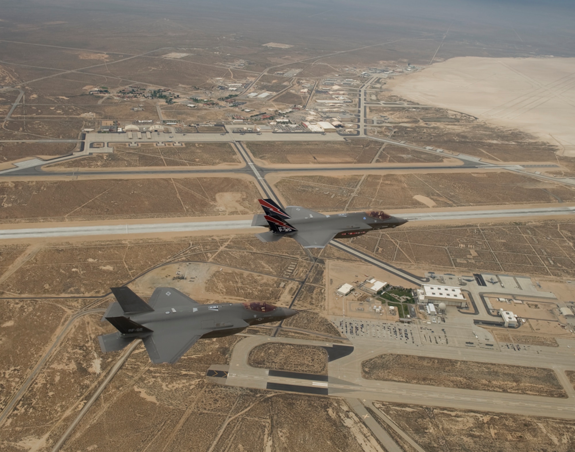 AF-01 and AF-02, F-35 Lighting II Joint Strike Fighters, fly over Edwards Air Force Base prior to their landing the afternoon of May 17.