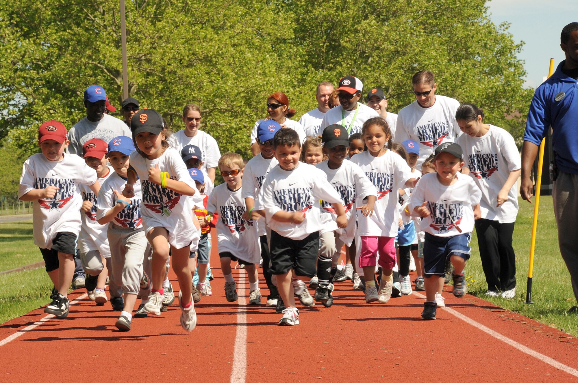 Children, coaches and parents begin the half-mile run during the Armed Forces Kids Run here Saturday. The annual event was hosted by the 87th Force Support Squadron Youth Programs and featured a half-mile run for children ages 5-6, a one-mile run for children ages 7-9 and a two-mile run for children age 10 and up. (U.S. Air Force photo/Staff Sgt. Danielle Johnson)