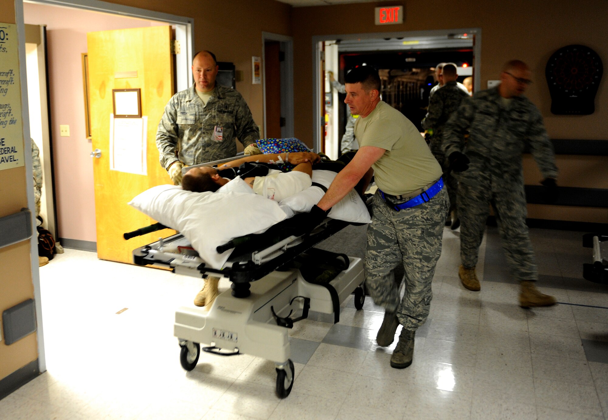 SCOTT AIR FORCE BASE, Ill. -- Aeromedical Staging Flight personnel transport wounded servicemembers from buses into the ASF wing of the hospital, May 15, 2010. The ASF at Scott serves as a transport hub for wounded servicemembers coming from overseas. The team here is responsible for picking up, housing, treating and moving the patients onward to their final location. (U.S. Air Force photo/ Senior Airman Ryan Crane)