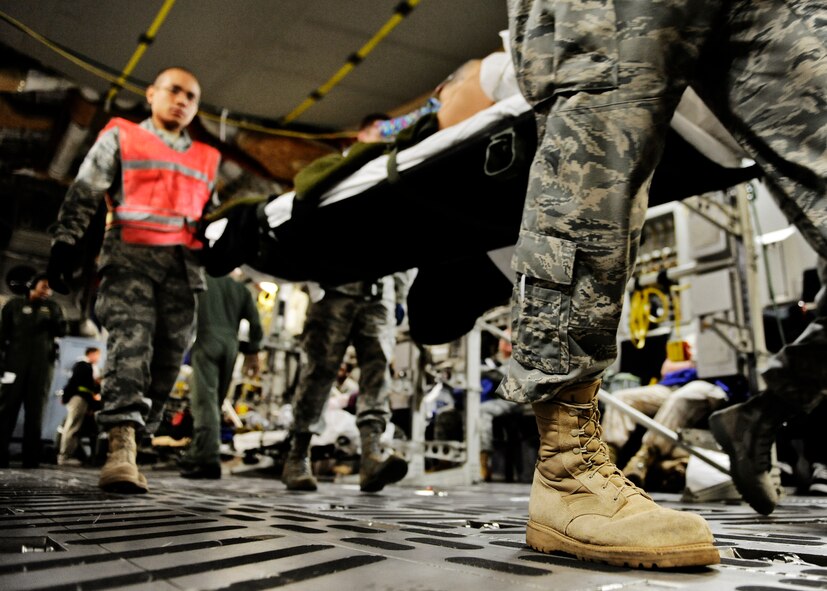 SCOTT AIR FORCE BASE, Ill. -- Aeromedical Staging Flight personnel transport wounded servicemembers from a C-17 Globemaster III onto buses to be transported to the ASF at Scott Air Force Base, May 15, 2010.  The ASF at Scott serves as a transport hub for wounded servicemembers coming from overseas. The team here is responsible for picking up, housing, treating and moving the patients onward to their final location. (U.S. Air Force photo/ Senior Airman Ryan Crane)