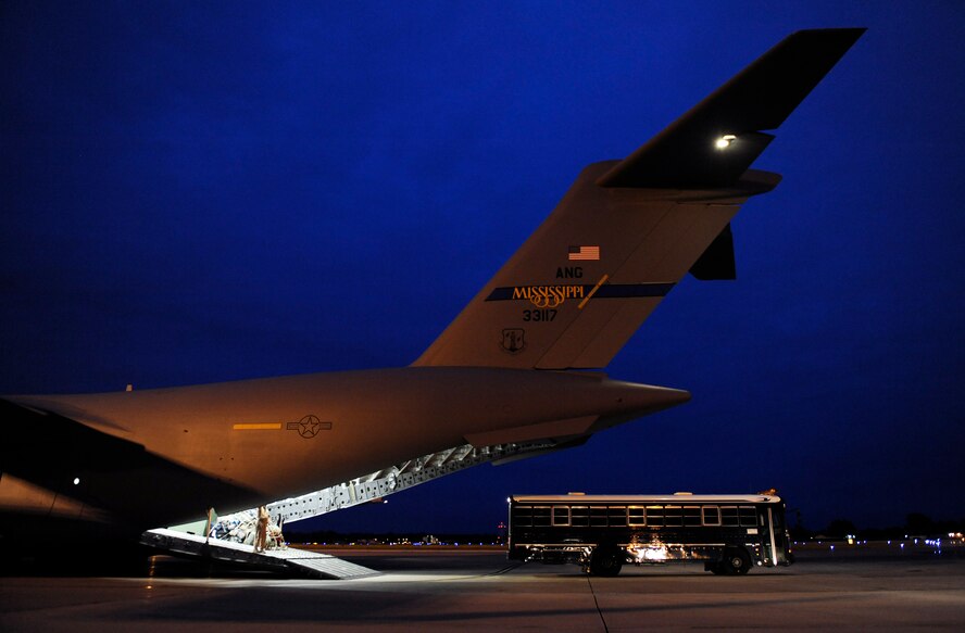 SCOTT AIR FORCE BASE, Ill. -- An Aeromedical Staging Flight bus backs up to a C-17 Globemaster III in preparation to receive wounded servicemembers and transport them to the ASF at Scott Air Force Base, May 15, 2010. The ASF at Scott serves as a transport hub for wounded servicemembers coming from overseas. The team here is responsible for picking up, housing, treating and moving the patients onward to their final location. (U.S. Air Force photo/ Senior Airman Ryan Crane)