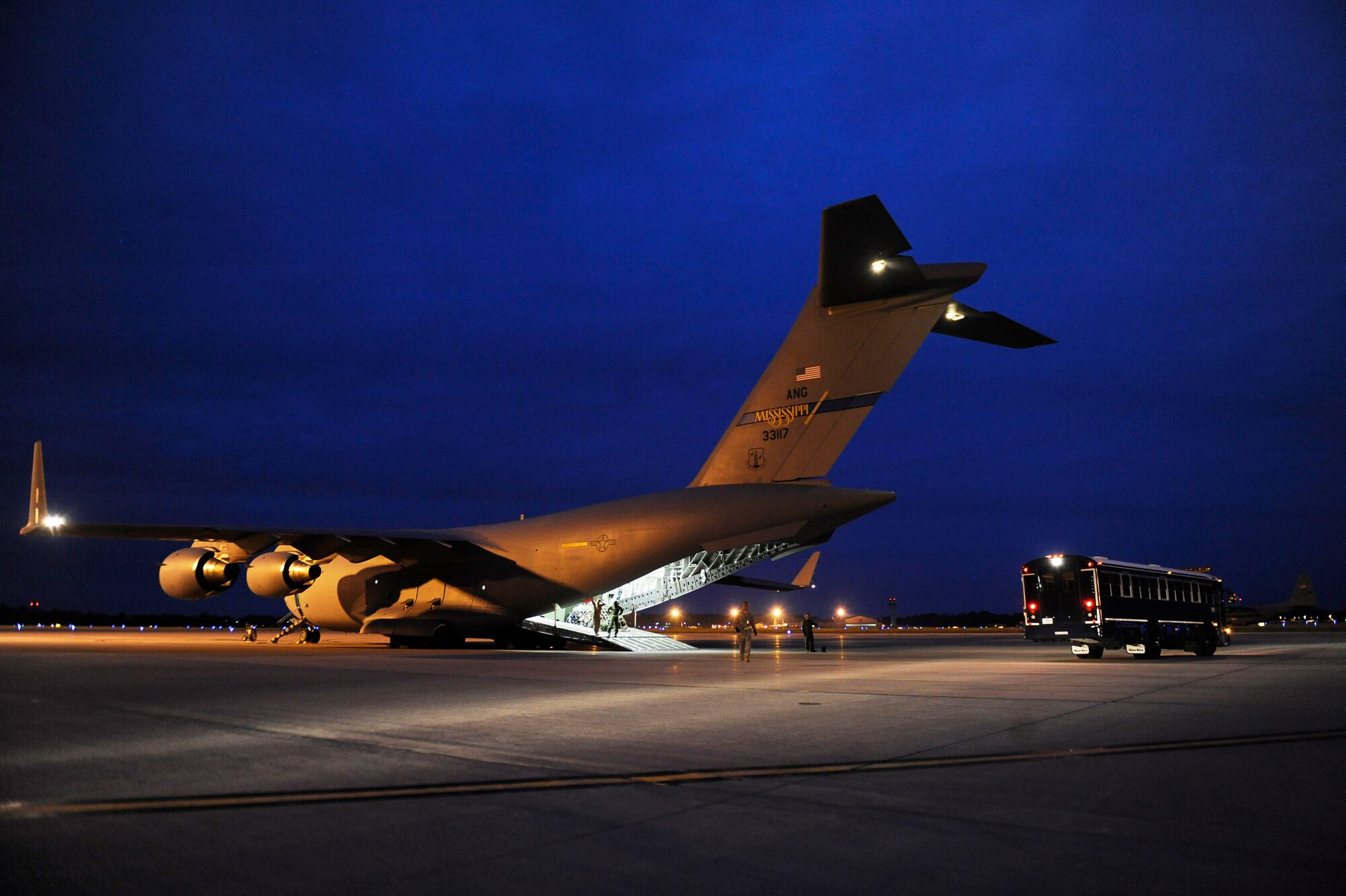 SCOTT AIR FORCE BASE, Ill. -- An Aeromedical Staging Flight bus backs up to a C-17 Globemaster III in preparation to receive wounded servicemembers and transport them to the ASF at Scott Air Force Base, May 15, 2010. The ASF at Scott serves as a transport hub for wounded servicemembers coming from overseas. The team here is responsible for picking up, housing, treating and moving the patients onward to their final location. (U.S. Air Force photo/ Senior Airman Ryan Crane)