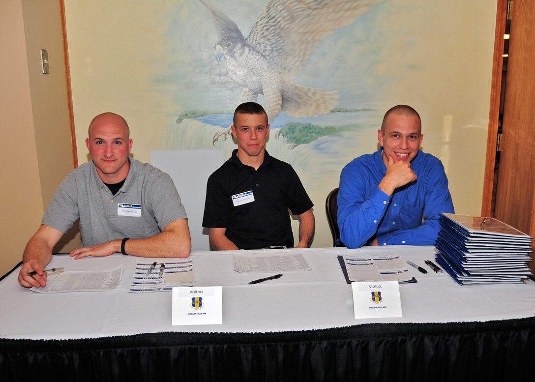 Members of the Rising Six, Senior Airmen Shaun Zelasko, Brett Schickler and Grayson Weil sign in guests and hand out booklets with meeting information to members of the HRDC during an ice-breaker reception at the Falcon Club May 17, 2010, Niagara Falls, NY. The Rising Six consists of all enlisted personnel ranking from Airmen Basic to Technical Sergeants. (U.S. Air Force photo by Staff Sgt. Joseph McKee)