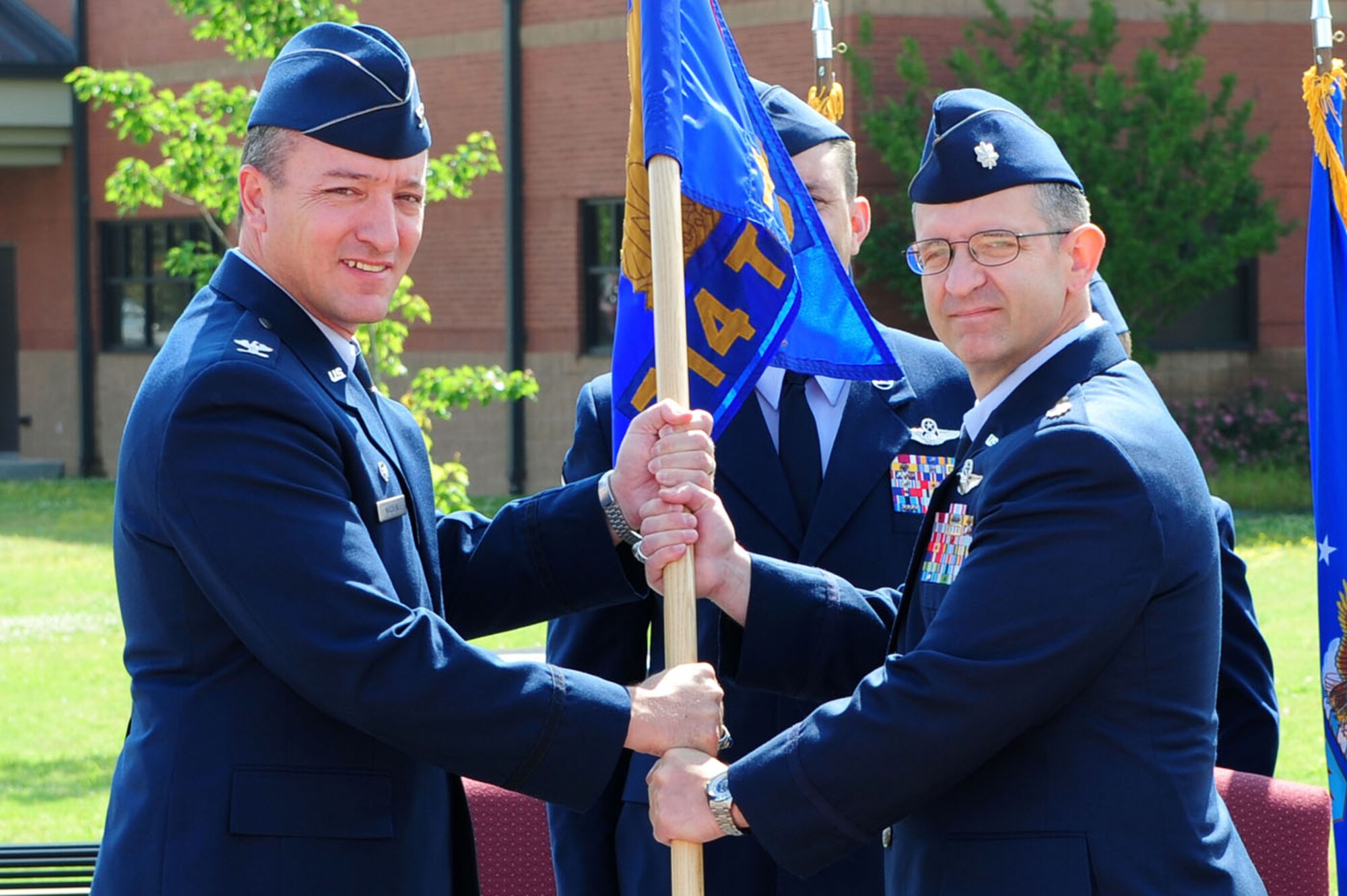 LITTLE ROCK AIR FORCE BASE, Ark. -- Col. Patrick Mordente, 314th Operations Group commander, passes the 714th Training Squadron guidon to Lt. Col. Mark Livelsberger, 714th TRS commander, upon his assumption of command during a ceremony May 17 at the C-130 Center of Excellence on base. Col. Livelsberger assumed command after Lt. Col. Philip Everitte relinquished command. (U.S. Air Force photo by Senior Airman Steele C. G. Britton)