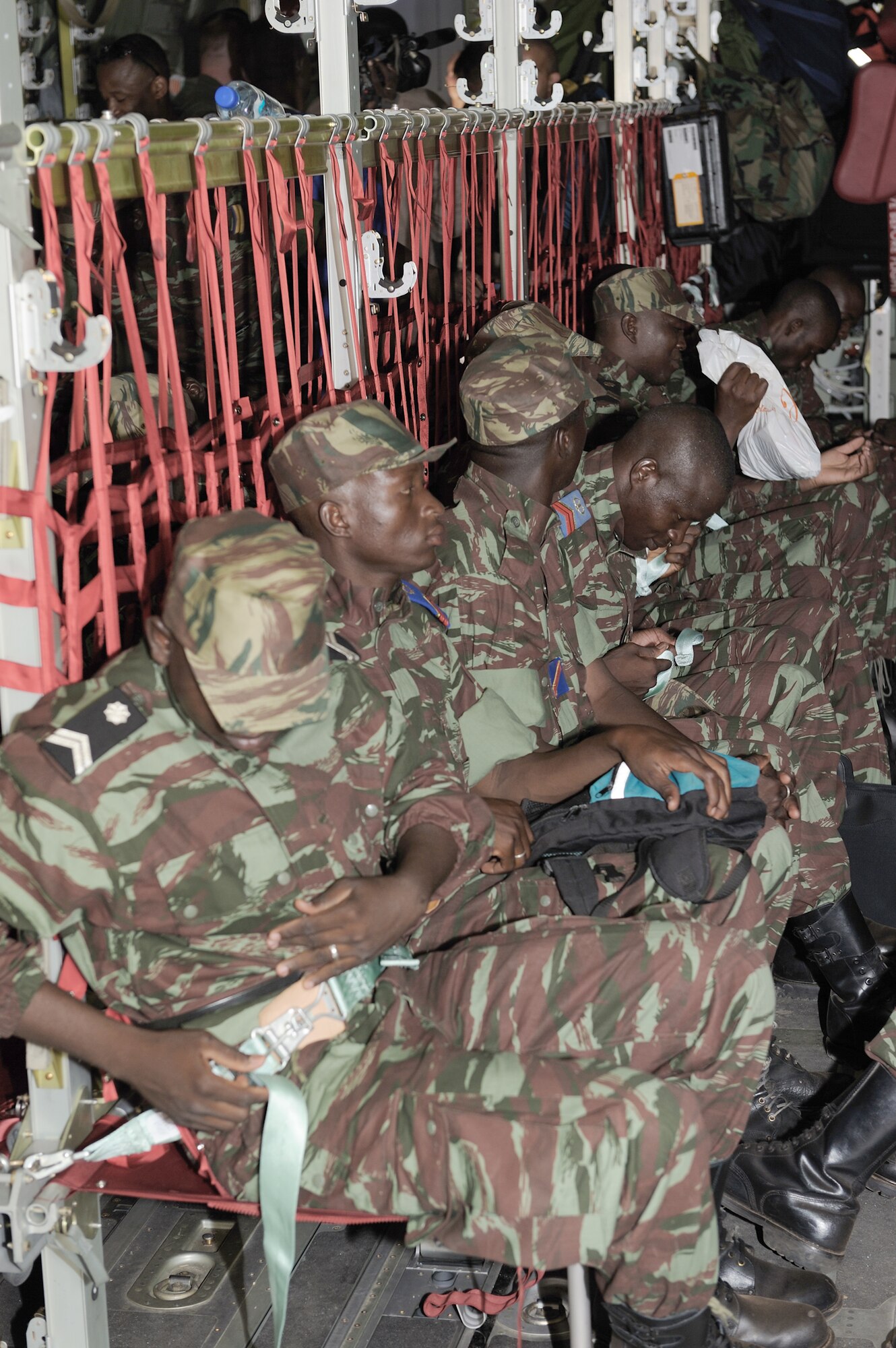 Burkinabe army soldiers buckle themselves into a C-130J Super Hercules to begin their deployment to Mali in support of Exercise Flintlock 10 May 1, 2010, in  Ouagadougou, Burkina Faso. The C130-J is deployed from Ramstein Air Base, Germany.(U.S. Air Force photo/Master Sgt. Jeremiah Erickson)