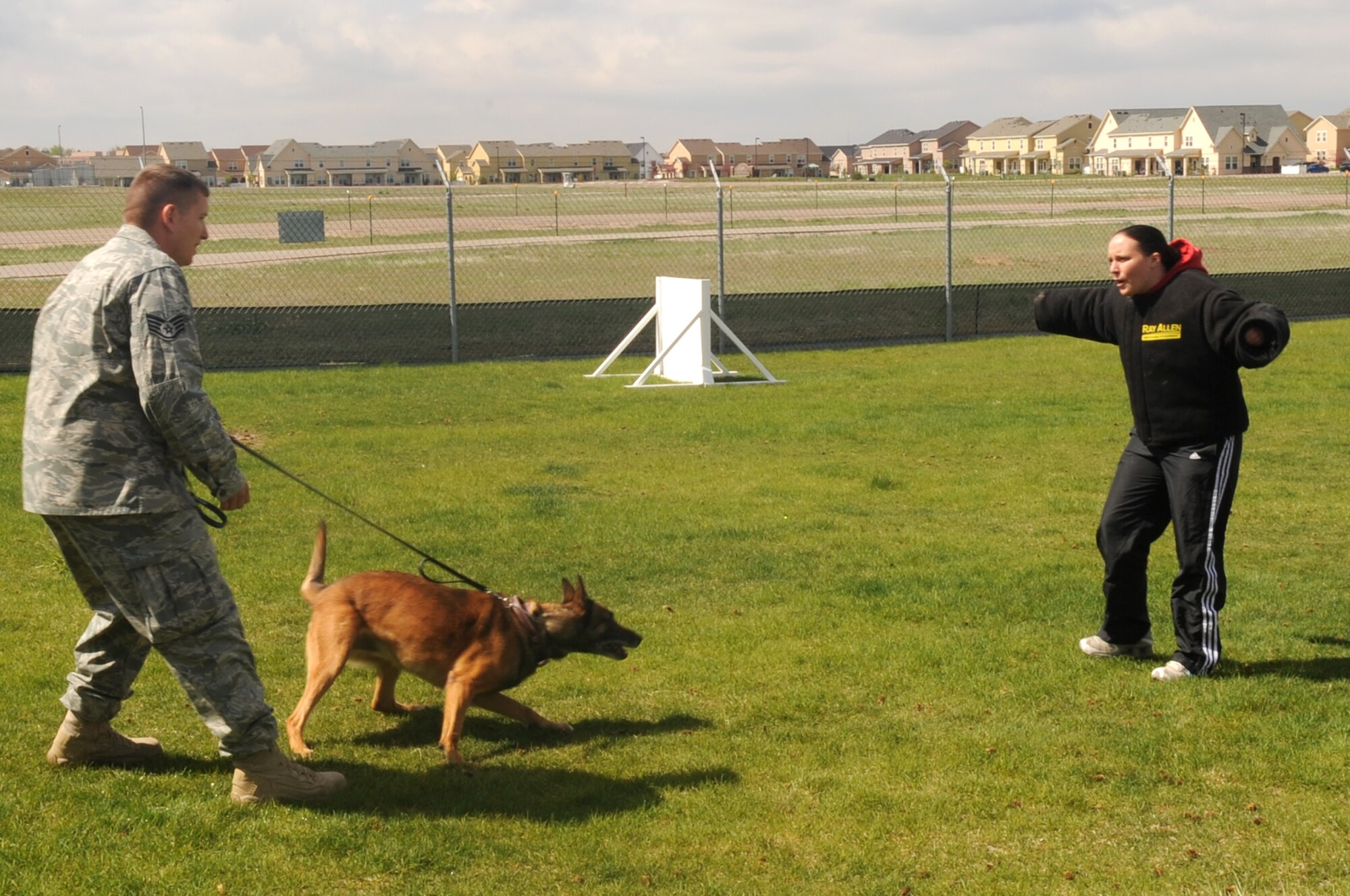 BUCKLEY AIR FORCE BASE, Colo. -- Staff Sgt. Charles Dalton, 460th Security Forces Squadron, and Buck, 460th SFS military working dog, demonstrate takedown procedures on Staff Sgt. Nicole Gladkowski, 460th SFS, May 13. Buck is one of six MWDs at Buckley. (U.S. Air Force photo by Airman 1st Class Manisha Vasquez)