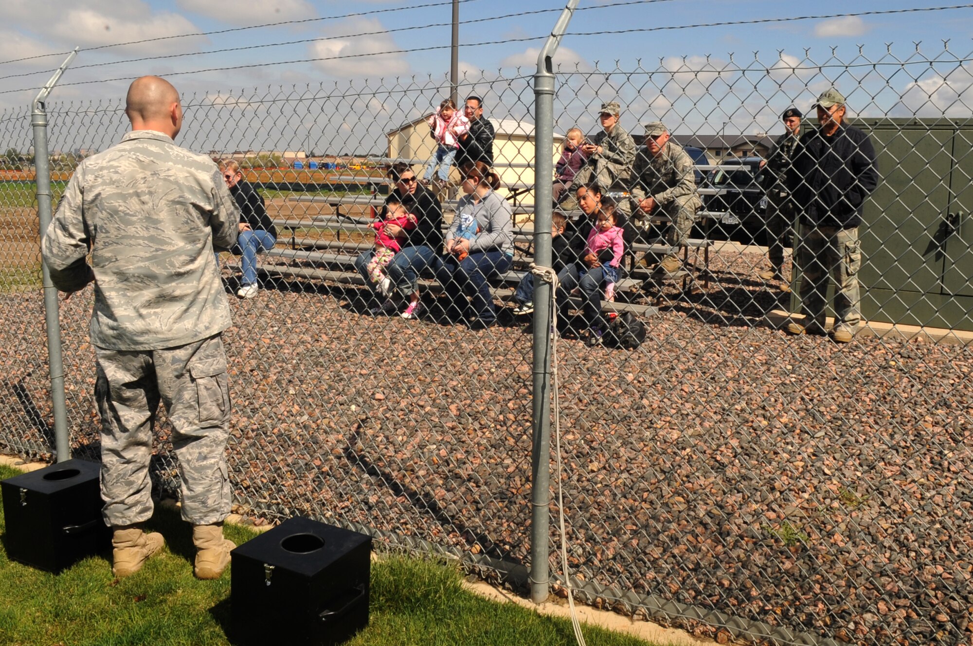 BUCKLEY AIR FORCE BASE, Colo.-- Tech. Sgt. Edward Canell, 460th Security Forces Squadron, speaks to members of Team Buckley at the K9 demonstration at May 13 in support of National Police Week. (U.S. Air Force Photo by Airman 1st Class Manisha Vasquez)