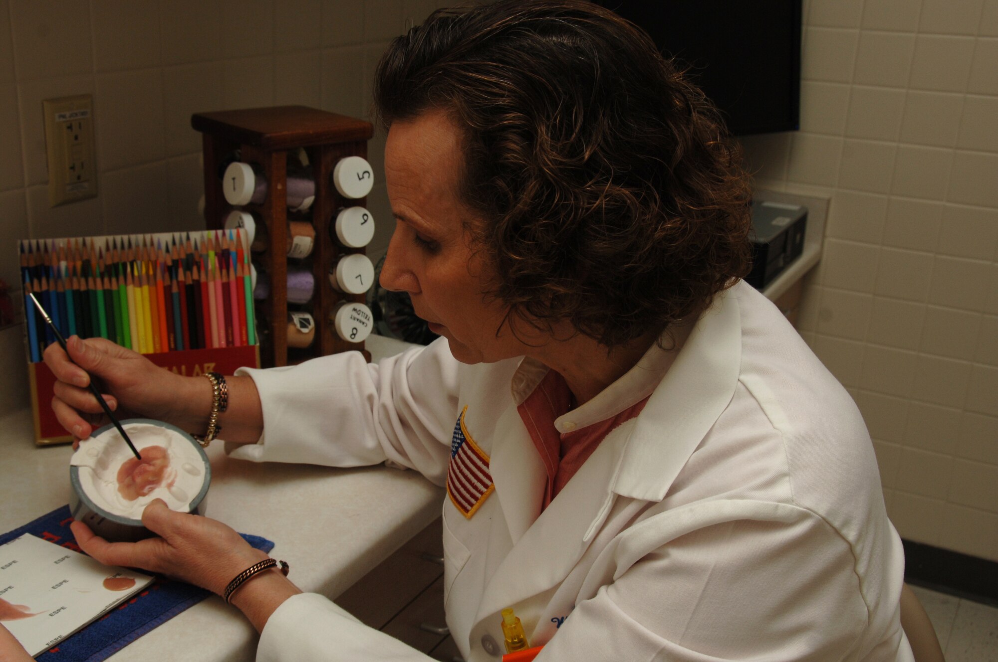Ms. Nancy Hansen, anaplastologist, Maxillofacial Department, 59th Dental Training Squadron, works on a prosthetic ear May 7 at MacKown Dental Clinic, Lackland Air Force Base, Texas. She works to give the prosthesis a realistic look and is the only certified clinical anaplastologist in the Department of Defense.  (U.S. Air Force photo by Senior Airman Nicole Mickle) 
