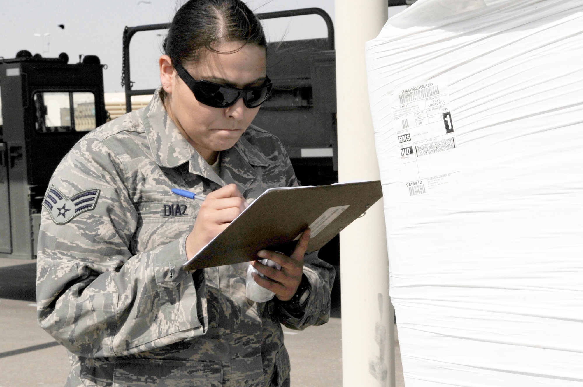 Senior Airman Anita Diaz, an air transportation journeyman with the 380th Expeditionary Logistics Readiness Squadron's Air Terminal Operations Center supporting operations for the 380th Air Expeditionary Wing, calculates data for a pallet of cargo at a non-disclosed base in Southwest Asia on Feb. 16, 2010. Airman Diaz is deployed from the 89th Aerial Port Squadron at Joint Base Andrews, Md., and her hometown is Merced, Calif. (U.S. Air Force Photo/Capt. Cathleen Snow/Released)