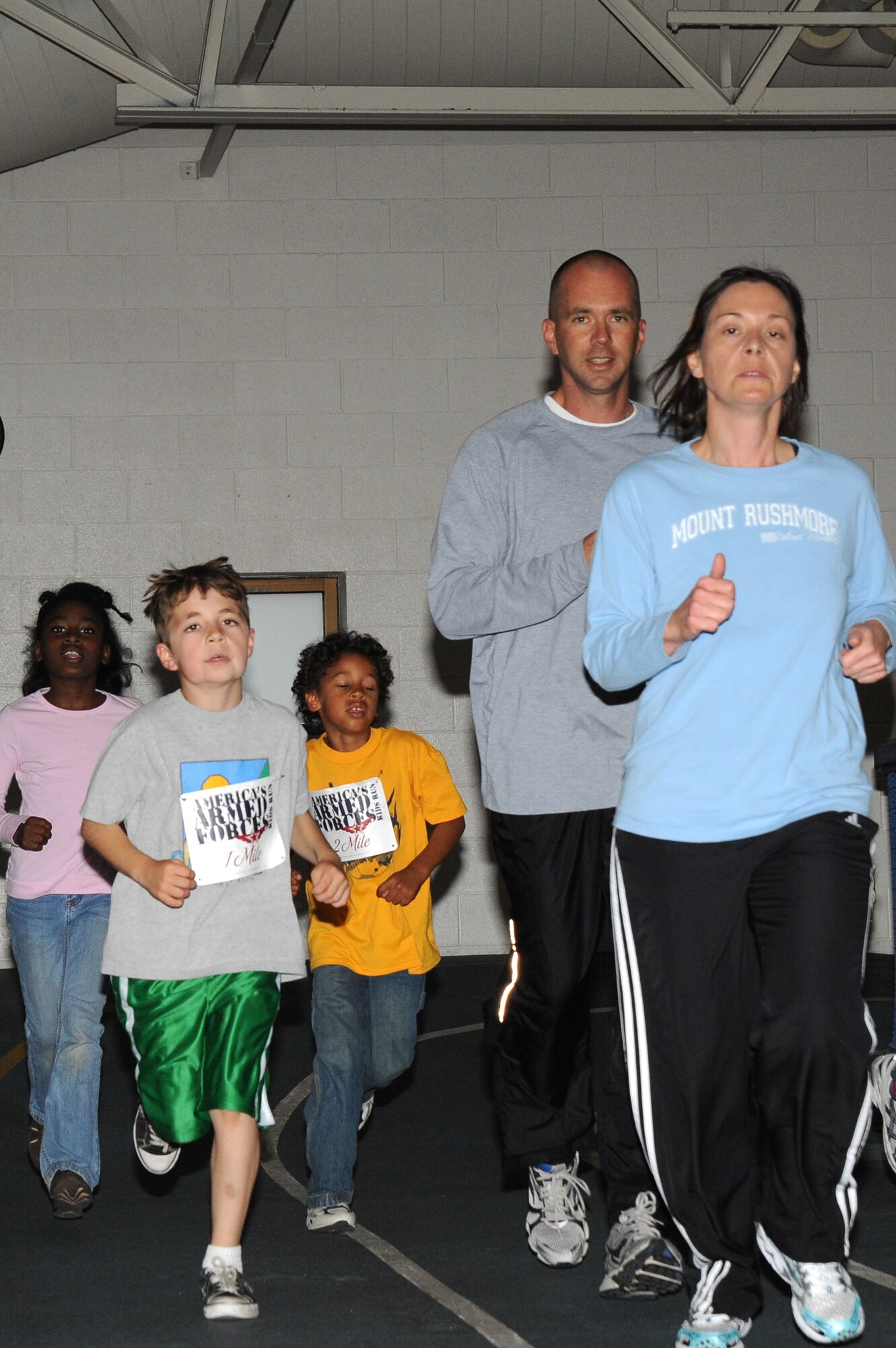 Team McConnell family members participate in the America’s Kids Run, May 15, 2010, at the indoor track, McConnell Air Force Base, Kan.  America's Kids Run is the largest children's running event worldwide through participation on military bases in the United States and abroad.  More than 35 Team McConnell family members including children, ages 5 to 18, ran 1/2 mile, 1 mile, and 2 mile events totaling 23 miles in the 25th America’s Kids Run.  McConnell’s youth program, which supports more than 2,150 children, organized the base event. (U.S. Air Force photo/Tech. Sgt. Chyrece Campbell)