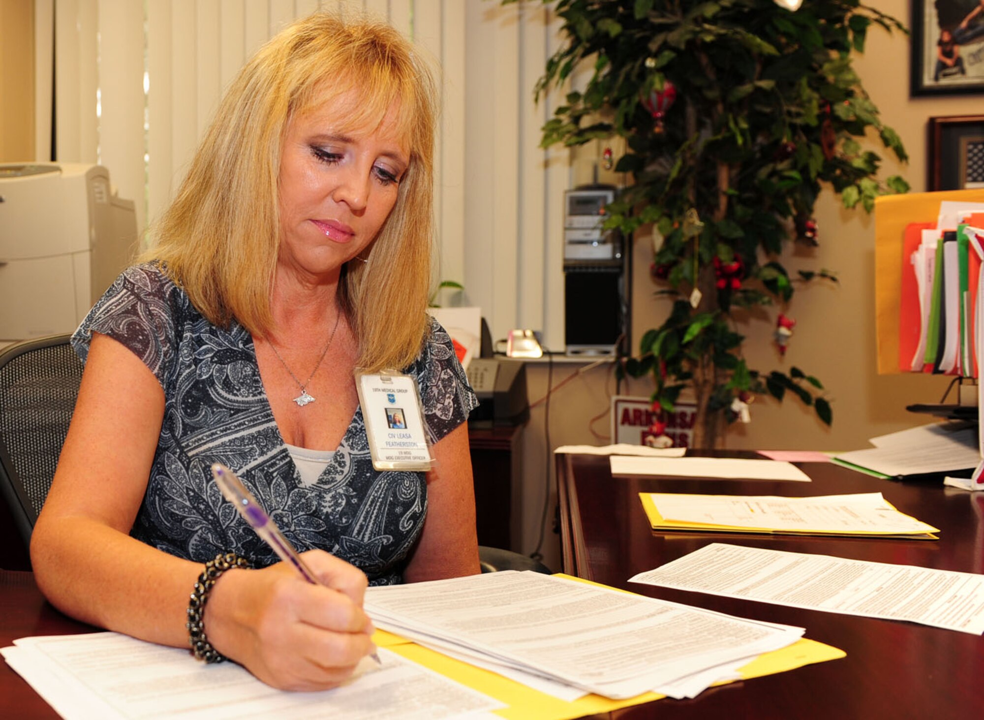 Ms. Featherston reviews nearly all documents that affect her group and the three squadrons within, ensuring products are accurately and delivered on time. She takes the lead for patient concerns, helping to address and solve issues quickly, with a minimum amount of bureaucracy. (Photo by Senior Airman Steele C.G. Britton)