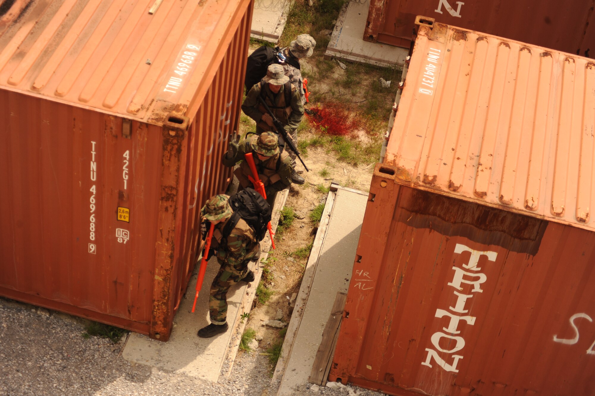 A team of Survival, Evasion, Resistance and Escape students moves through a simulated urban environment during combat survival training at an undisclosed location in the Eglin Range, Fla., May 13, 2010. The team conducted scenarios
while evading members of the 1st Special Operations Support Squadron Range Support flight opposition forces team. (DoD photo by U.S. Air Force Senior Airman Matthew Loken)