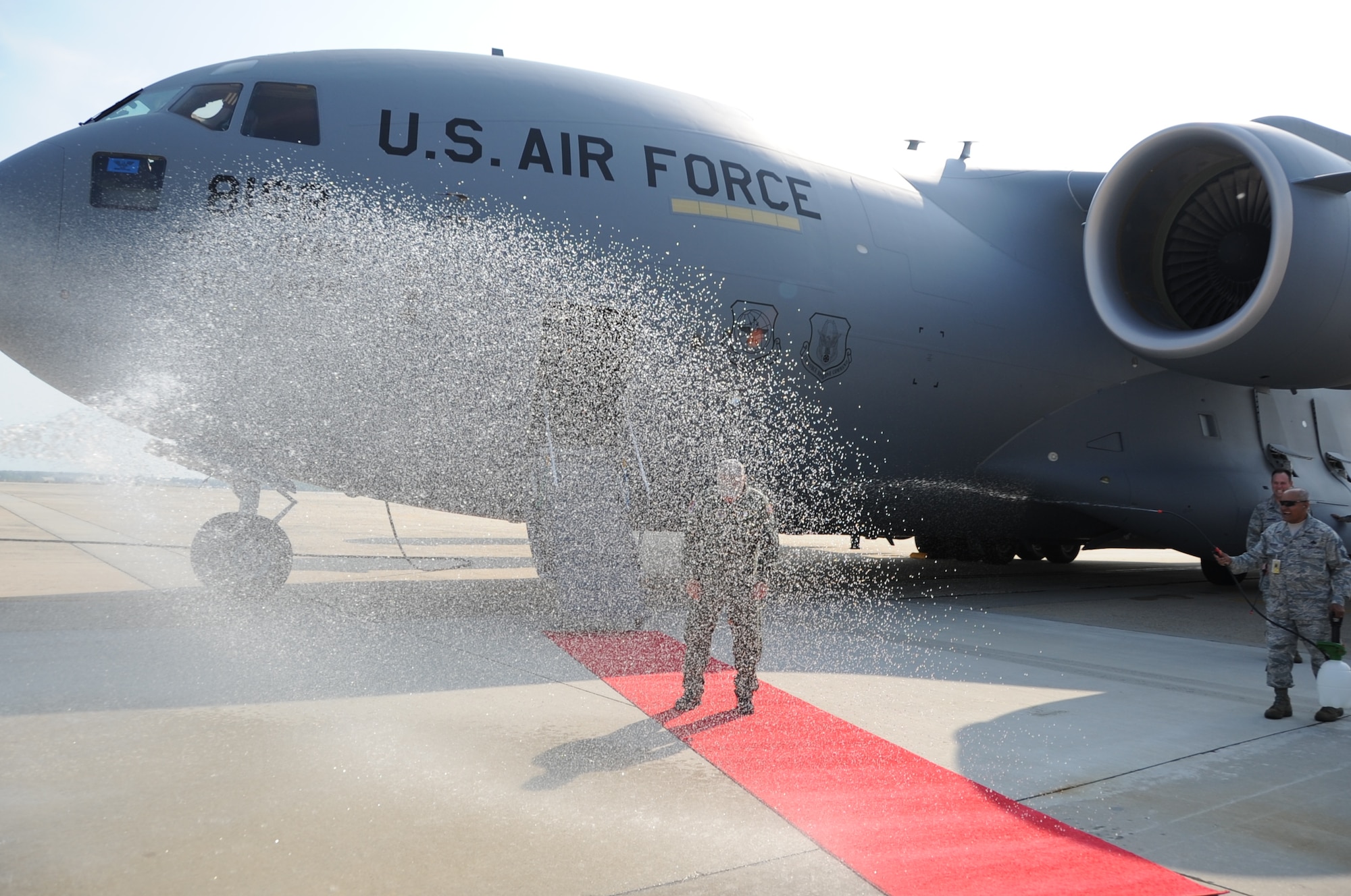 Col. James Weber, 305th Maintenance Group commander, is hosed down in celebration of the final flight of his Air Force career. The flight  took place during the inaugural flight of the 305th and 514th Air Mobility Wings' newest C-17 Globemaster . (U.S. Air Force photo/2nd Lt. Carolyn Glover)