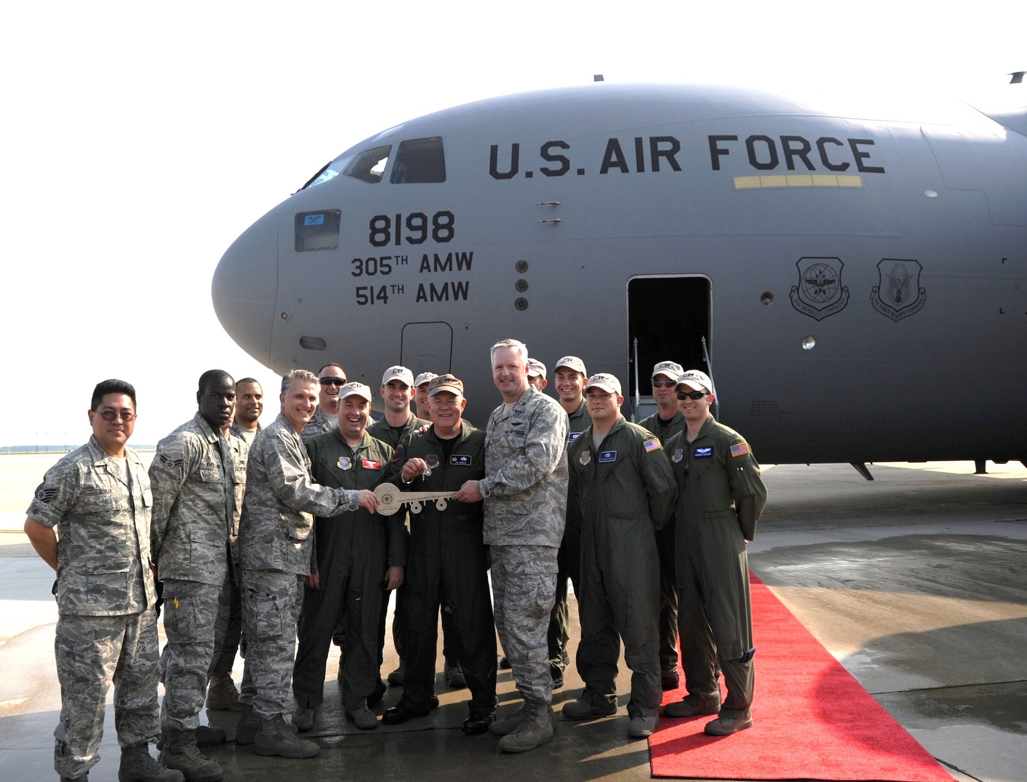 Col. Giordano McMullen, 514th Air Mobility Wing commander, Col. James Weber, 305th Maintenance Group commander, and Col. Scott Smith, 305th Air Mobility Wing commander, stand in front of the 305th  and 514th Air Mobility Wings' newest aircraft with the inaugural flight crew. This aircraft is the first of three new C-17 Globemaster III aircraft assigned to the wing as part of a congressionaly-approved increase in the aircraft throughout Air Mobility Command (U.S. Air Force photo/2nd Lt. Carolyn Glover)