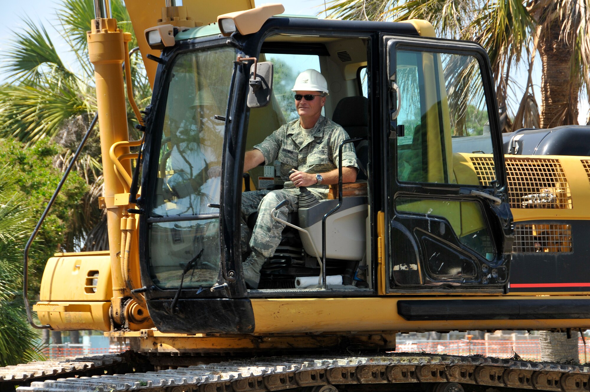 Col. James Browne, 325th Fighter Wing commander, operates a CATERPILLAR 330C Excavator while demolishing an old building at Tyndall Air Force Base May 17.   (U.S. Air Force photo by Lisa Norman)