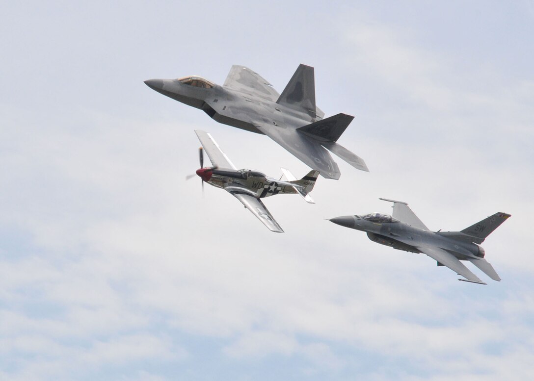 JOINT BASE ANDREWS, Md. – An F-22 Raptor, P-51 Mustang and an F-16 Fighting Falcon fly in formation during a U.S. Air Force Heritage Flight over the flightline here during the 2010 Joint Service Open House May 16. The Heritage Flight program presents the evolution of U.S. Air Force air power by flying today's state-of-the-art fighter aircraft in close formation with vintage fighter aircraft. JSOH offers an opportunity for the public to see military equipment from the Navy, Marines, Army, Air Force and Coast Guard. (U.S. Air Force photo by Airman 1st Class Kat Lynn Justen)