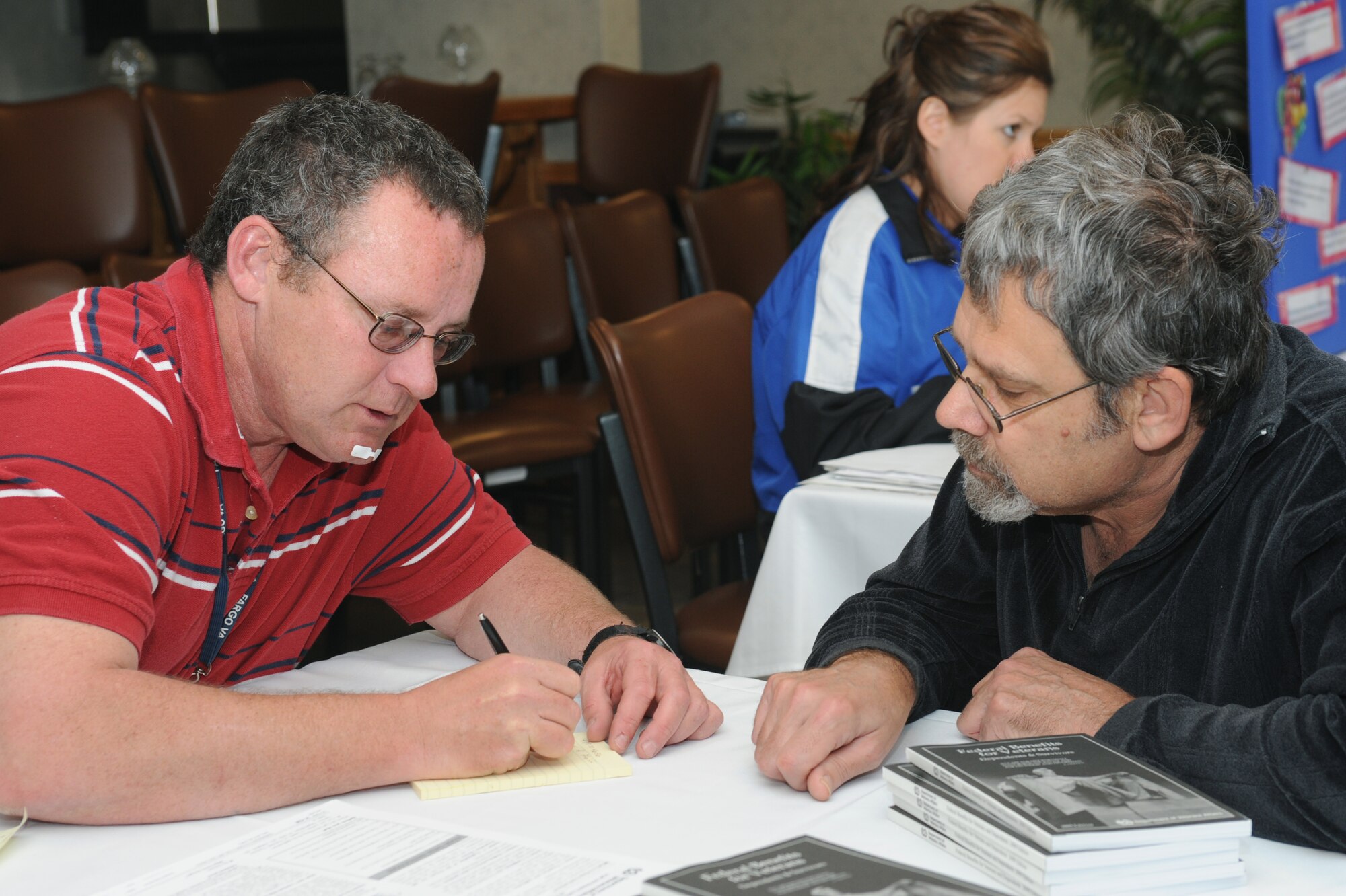 Michael Olson (left), Department of Veterans Benefit counselor advises a retiree of 15 years, Steve Pfeiff (right) May 15, Grand Forks Air Force Base, N.D., on benefits for veterans. Mr. Pfeiff attended the Retiree Appreciation Day that was held to support Air Force retirees. (U.S. Air Force photo by Airman 1st Class Amber Price)