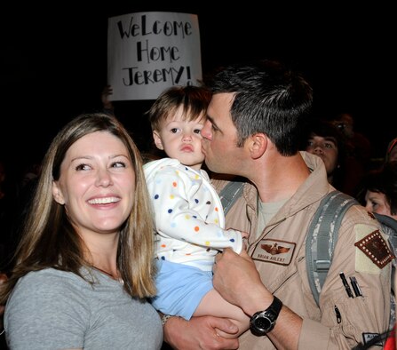 Maj. Brian Ahlert, right, reunites with his son and wife, Ashley, May 17, 2010. Ahlert was one of more than 200  members of the Arkansas Air National Guard's 188th Fighter Wing that returned to home station Monday following an Aerospace Expeditionary Force (AEF) deployment to Kandahar Airfield in Afghanistan. (U.S. Air Force photo by Capt. Heath Allen)