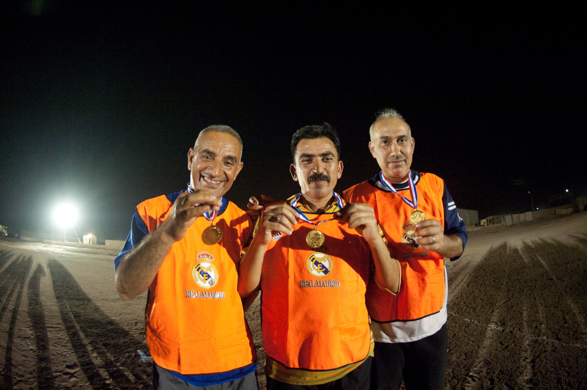 Three Iraqi Air Force crew chiefs  display their second place medals during a football or soccer tournament, held at New Al Muthana Air Base, Iraq, May 17, 2010. The tournament promotes camaraderie, sportsmanship and building partnerships among coalition forces. (U.S. Air Force photo by Senior Master Sgt. Elizabeth Gilbert/released)