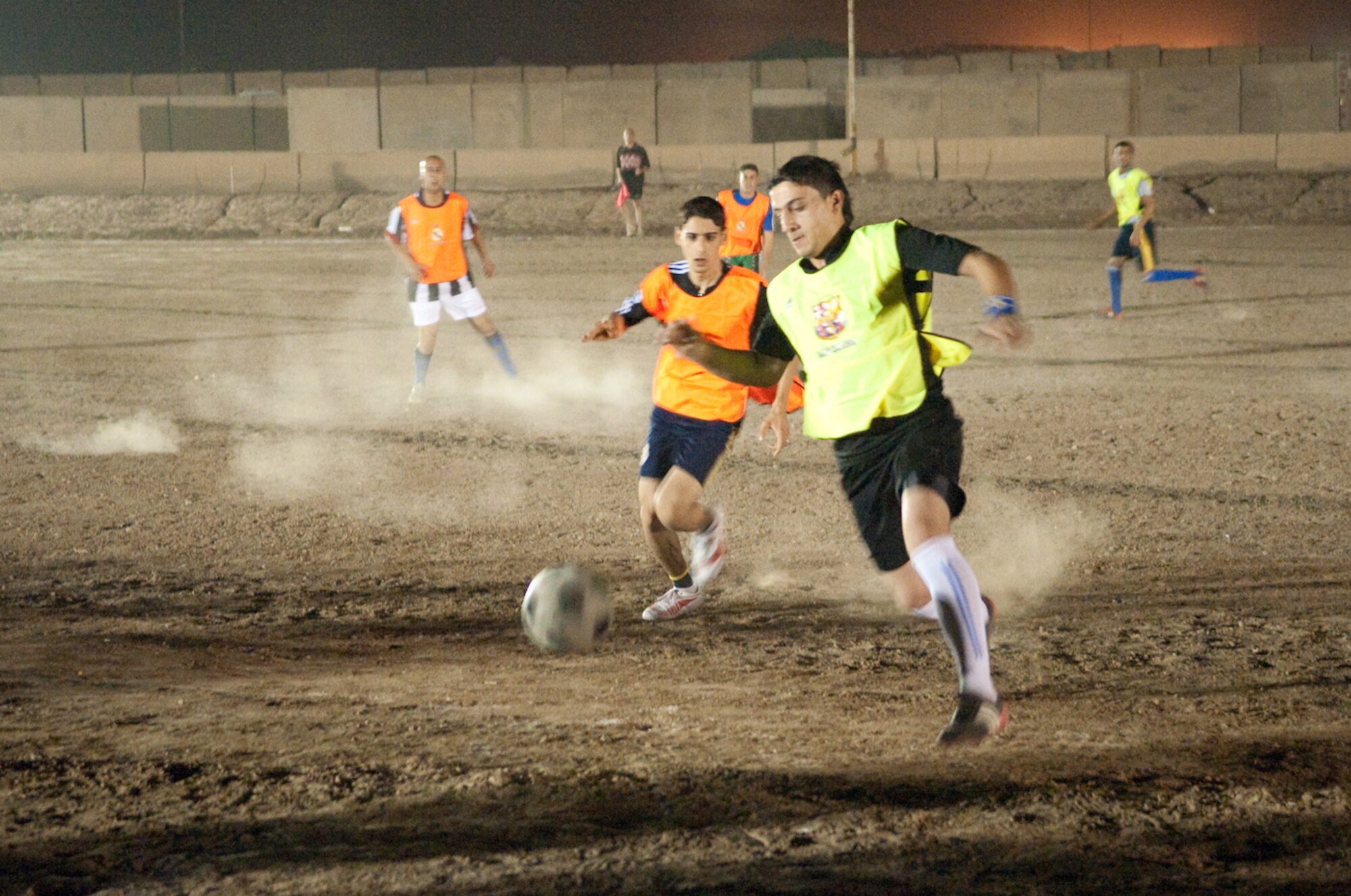 Members of the Iraqi Air Force from New Al Muthana Air Base Iraq vigorously play football or soccer for the coveted first place trophy during a tournament held at the air base May 17, 2010. The U.S. Air Force, 321st Air Expeditionary Wing members took third place during the tournament promoting camaraderie and partnership among coalition forces. (U.S. Air Force photo by Senior Master Sgt. Elizabeth Gilbert/released)