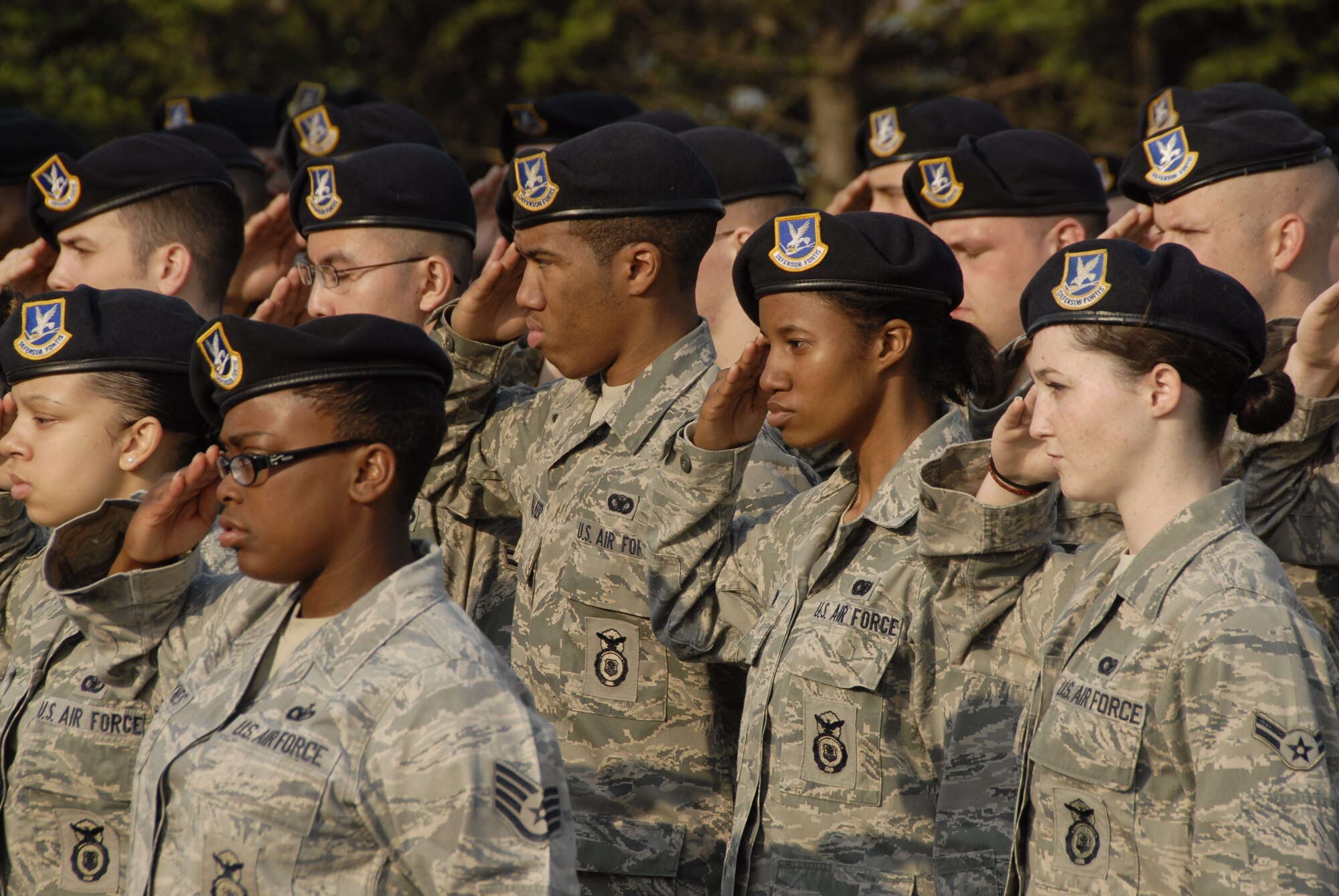 51st Security Forces Squadron Airmen salute during a retreat ceremony outside of the 51st Fighter Wing headquarters building at Osan Air Base, Republic of Korea, May 14. The ceremony was part of National Police Week, established in 1962 by President John F. Kennedy to pay tribute to law enforcement officers who lost their lives in the line of duty for the safety and protection of others, according to the National Peace Officer's Memorial Fund website. (U.S. Air Force photo/Staff Sgt. Eric Burks)