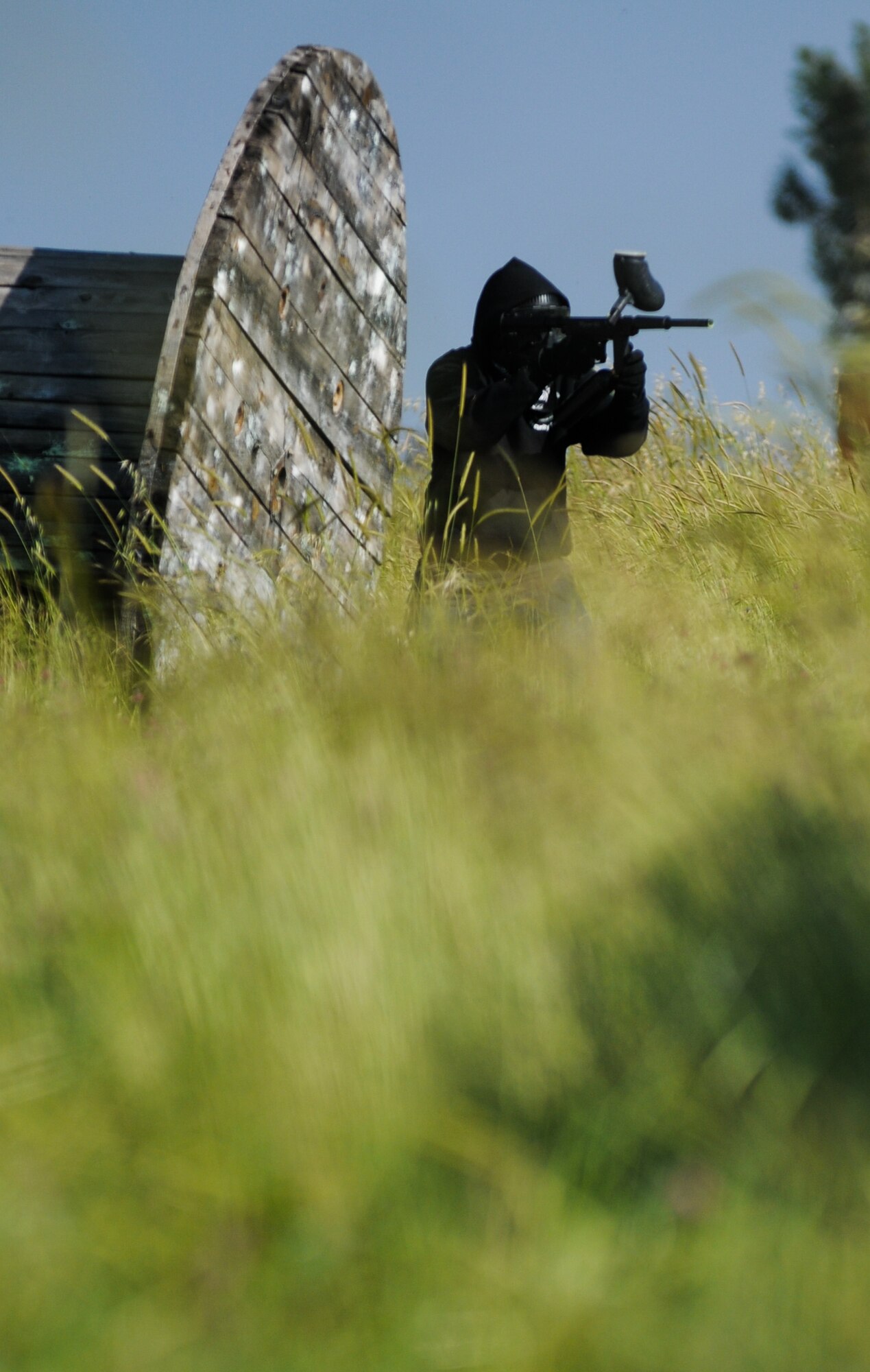An Airman from the 39th Security Forces Squadron aims his paintball gun at a member of the opposing team during a paintball tournament as a part of Police Week Thursday, May 13, 2010 at Incirlik Air Base, Turkey. (U.S. Air Force photo/Senior Airman Sara Csurilla)