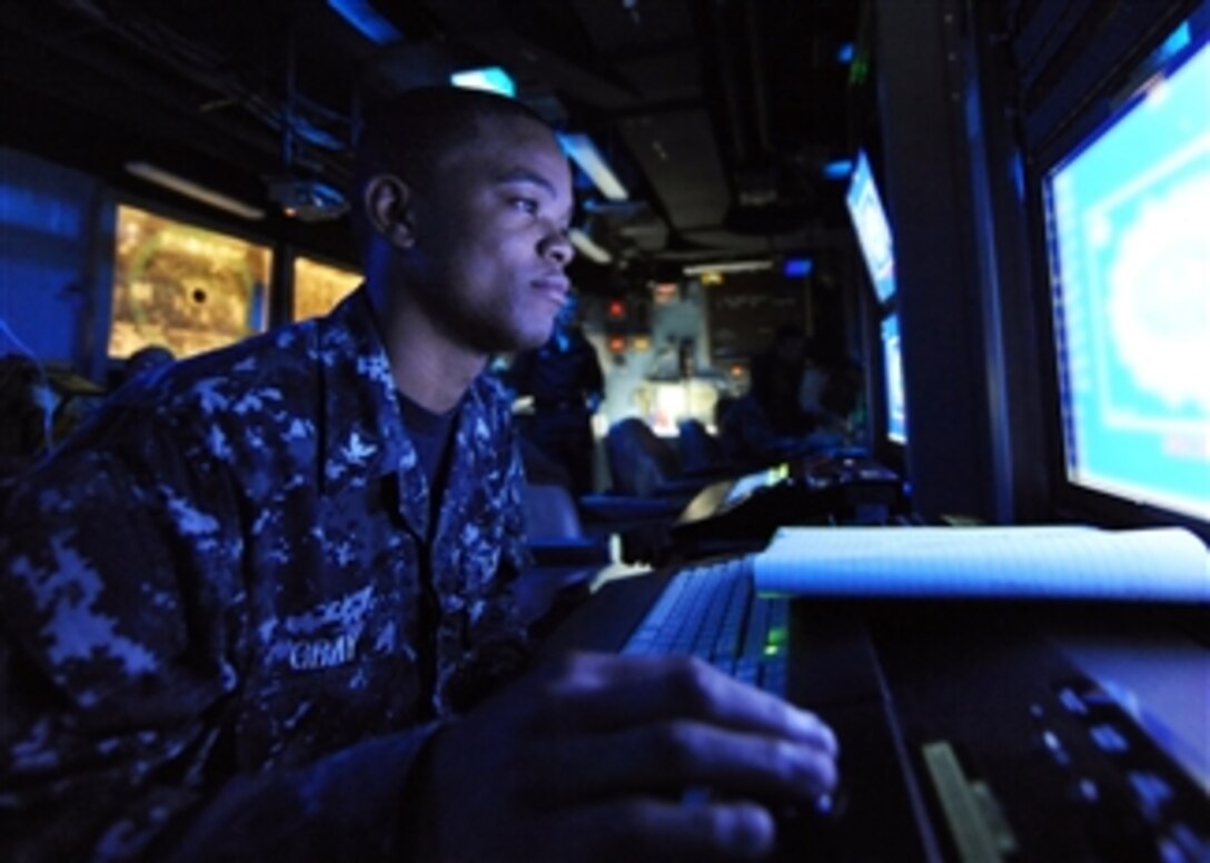 U.S. Navy Petty Officer 3rd Class Gregory L. Gray mans his station in the combat direction center aboard the aircraft carrier USS Enterprise (CVN 65) in the Atlantic Ocean on May 13, 2010.  The Enterprise is conducting flight deck certification in preparation for workups leading to its 21st deployment.  