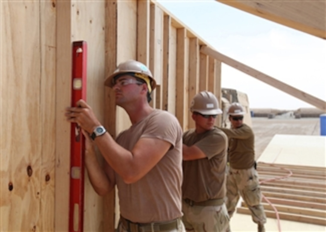 U.S. Navy Seabees from Naval Mobile Construction Battalion 133’s Detail Delaram II place walls during the construction of a Southwest Asia hut at a forward operating base in Delaram, Afghanistan, on April 28, 2010.  The hut will be used as an Afghanistan National Army command building.  Naval Mobile Construction Battalion 133 is in the U.S. Central Command area of operation.  