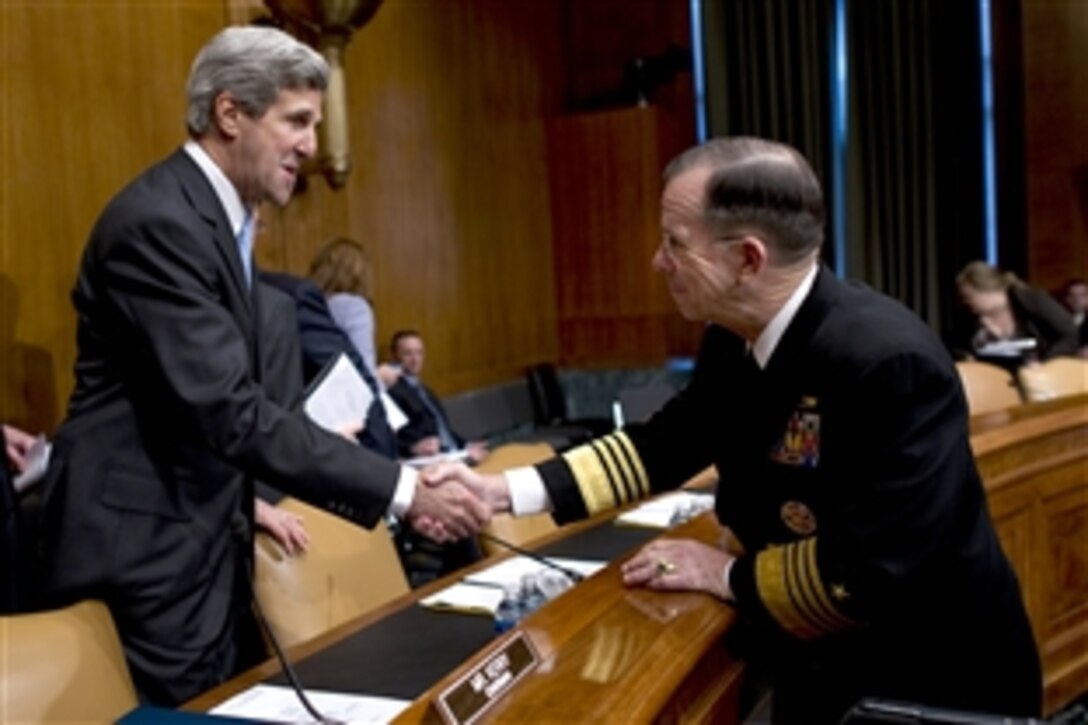 Navy Adm. Mike Mullen, right, chairman of the Joint Chiefs of Staff, greets U.S. Sen. John Kerry, D-Mass., chairman of the Senate Foreign Relations Committee, before testifying on the U.S.-Russian Strategic Arms Reduction Treaty, Dirksen Senate Office Building, Washington, D.C., May 18, 2010.