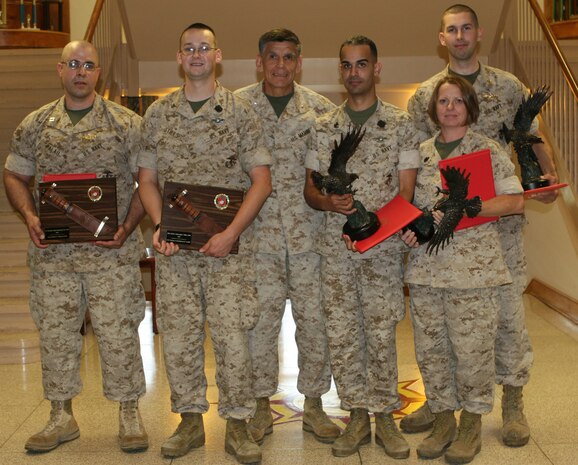 Sailors stand with the 2nd Marine Logistics Group commanding general, Brigadier General Juan G. Ayala (center), after being presented awards aboard Camp Lejeune, N.C., May 19, 2010.  To the left of the general; Navy Lt. Wilfredo Palau-Hernandez (FMF) and Petty Officer Third Class Christopher Stills (FMF) received the 2009 Lieutenant Junior Grade Weeden E. Osborne and Dentalman Thomas A. Christensen Jr., Memorial Awards and the 2009 Navy and Marine Association Leadership Award respectively.  To the right of the general; Petty Officer Second Class Eric Javier Alamorosario (FMF), Chief Petty Officer Tiffany Jones (FMF) and Lt. John P. Walsh (FMF) received the Navy and Marine Association Leadership Award.