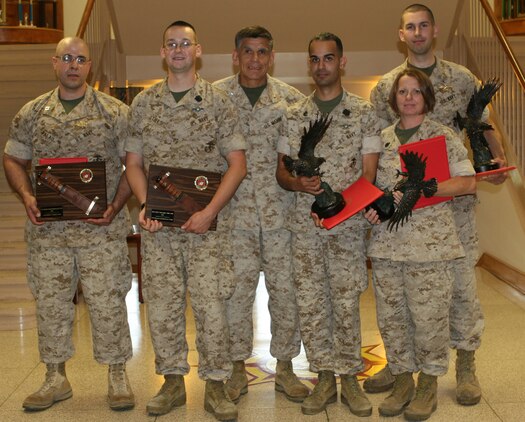 Sailors stand with the 2nd Marine Logistics Group commanding general, Brigadier General Juan G. Ayala (center), after being presented awards aboard Camp Lejeune, N.C., May 19, 2010.  To the left of the general; Navy Lt. Wilfredo Palau-Hernandez (FMF) and Petty Officer Third Class Christopher Stills (FMF) received the 2009 Lieutenant Junior Grade Weeden E. Osborne and Dentalman Thomas A. Christensen Jr., Memorial Awards and the 2009 Navy and Marine Association Leadership Award respectively.  To the right of the general; Petty Officer Second Class Eric Javier Alamorosario (FMF), Chief Petty Officer Tiffany Jones (FMF) and Lt. John P. Walsh (FMF) received the Navy and Marine Association Leadership Award.