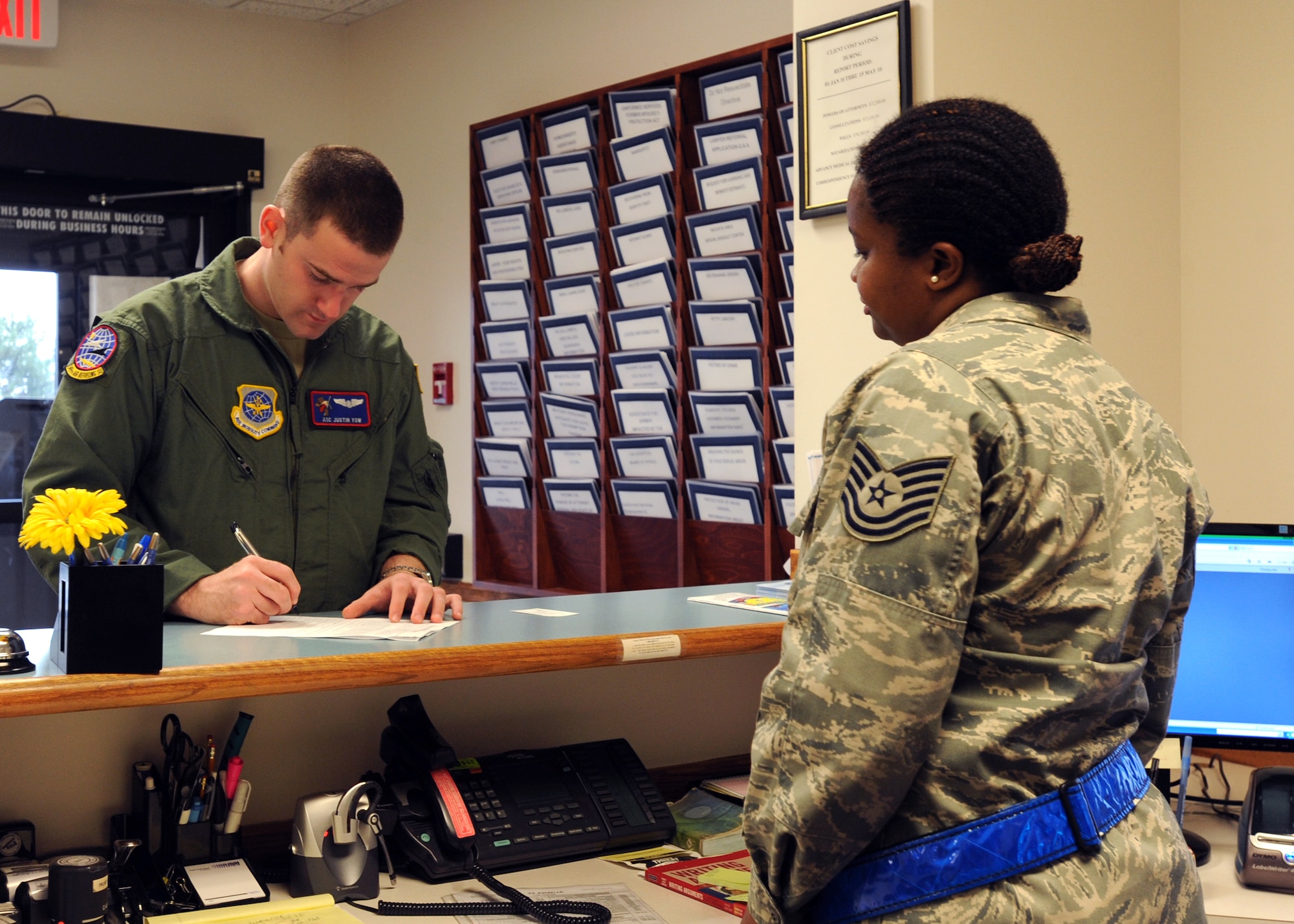 Airman 1st Class Justin Yow, 349th Air Refueling Squadron boom operator, completes an appointment letter for a Last Will and testament as Tech. Sgt. LaShawn Reed, 22nd Air Refueling Wing base legal office assistant, oversees the process May 19, 2010, McConnell Air Force Base, Kan. The legal office divided its staff into shifts to conduct 24-hour operations for an operational readiness exercise to help Airmen with any legal issues or questions in case of short notice deployments or emergencies.  (U.S. Air Force photo/Airman 1st Class Andrea Salazar)