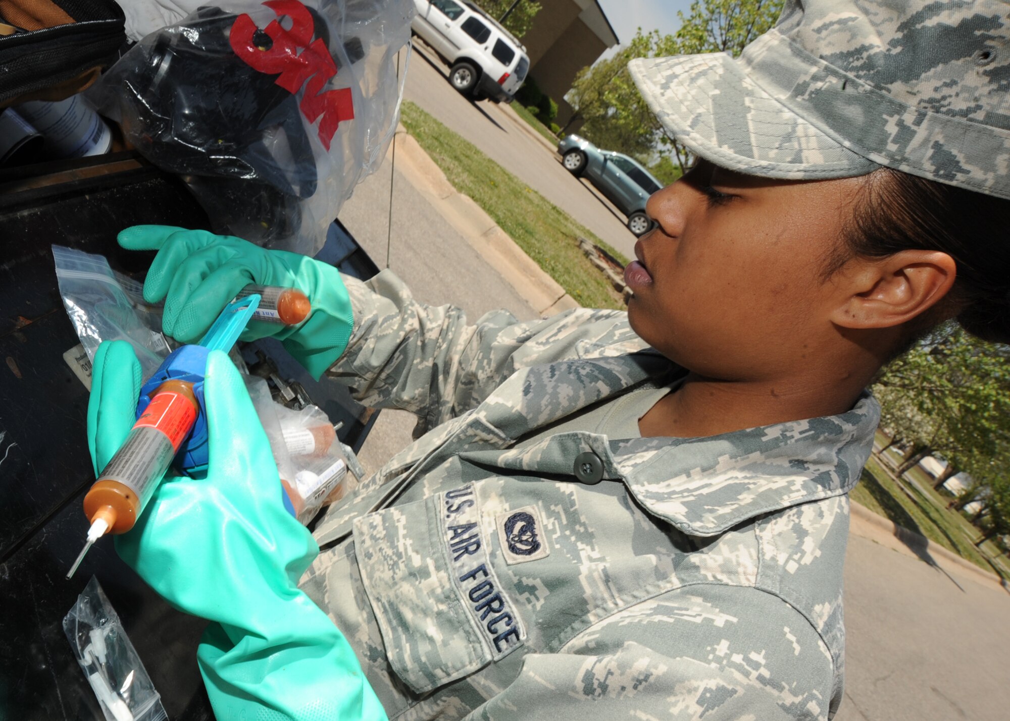 Airman 1st Class Cherleen Glass, 22nd Civil Engineer Squadron pest management apprentice, prepares roach killer bait gel at the Air Capital Inn April 14, 2010, McConnell Air Force Base, Kan.  This treatment lures roaches to the gel, which they will eventually take back to a nest, killing the rest of the nest within days. This treatment is typical for roaches and is less invasive than a spray treatment, preventing damage to appliances. The treatment is also safe for people. (U.S. Air Force photo/Senior Airman Maria Ruiz)