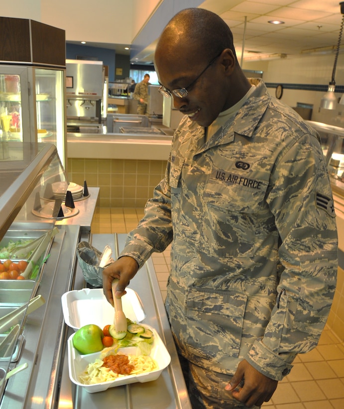 During the fitness-focused month of May, Senior Airman Joseph High, 882nd Training Group command support staff apprentice, practices nutritional awareness by adding an apple and a vegetable-packed salad to his lunch May 13, 2010.  Sheppard declared May as fitness month and offers classes at the Health and Wellness Center, such as Nutri-Fit, to educate the Airmen and community on nutrition basics, weight loss tips and fitness. (U.S. Air Force Photo/Airman 1st Class Adawn Kelsey)