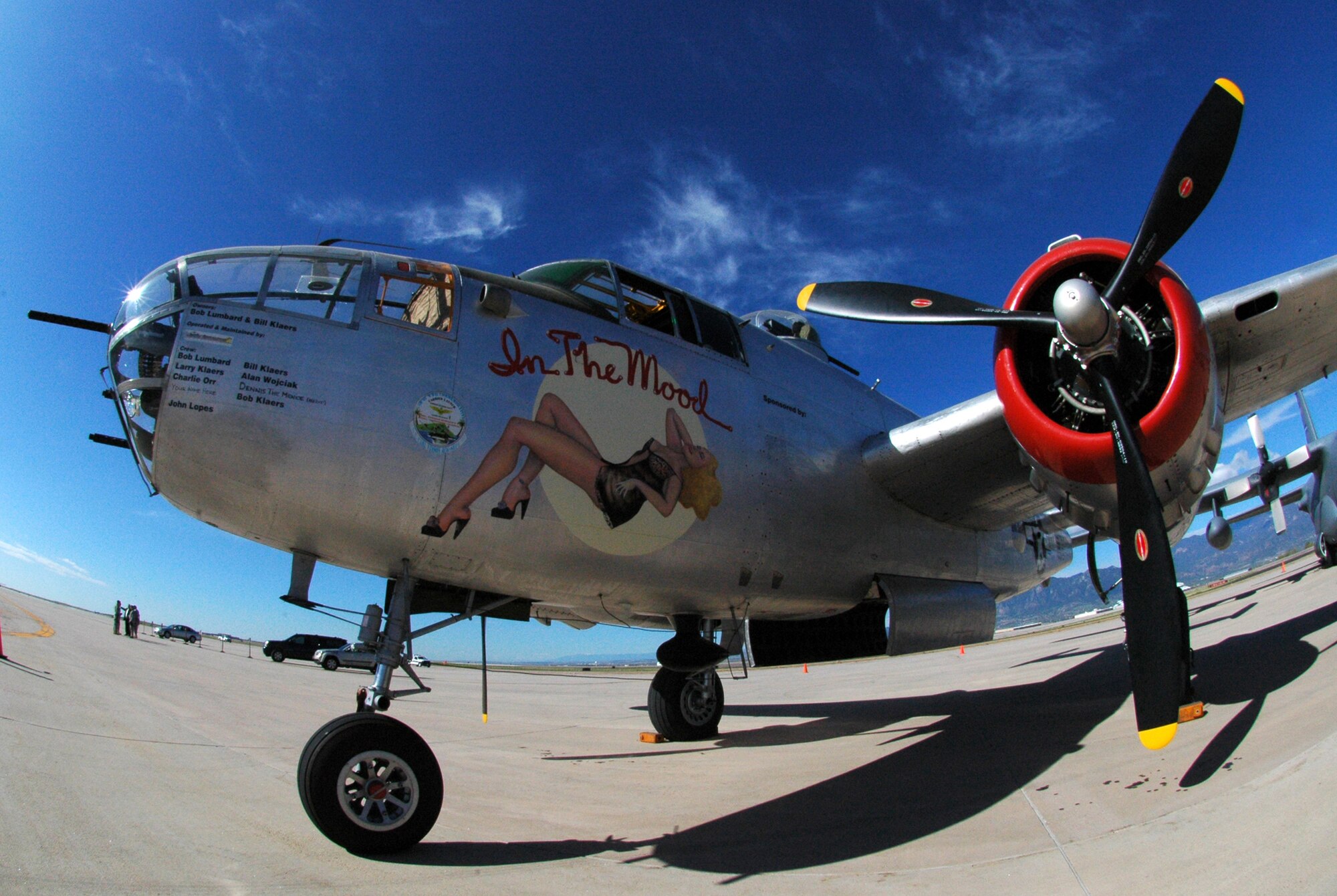 A World War II-era B-25 Mitchell medium bomber, named "In The Mood," stands ready more than 60 years later for a static display aircraft mission May 19 at Peterson Air Force Base, Colo. The bomber was parked next to a 302nd Airlift Wing C-130 Hercules (right) and was joined by a P-47 Thunderbolt, an F-15C Eagle, a Colorado Air National Guard F-16 Fighting Falcon and a Canadian CF-18 Hornet as part of a change of command ceremony for the North American Aerospace Defense Command and U.S. Northern Command organizations. The 302nd Airlift Wing is an Air Force Reserve Command-assigned unit. (U.S. Air Force photo/Staff Sgt. Stephen J. Collier)