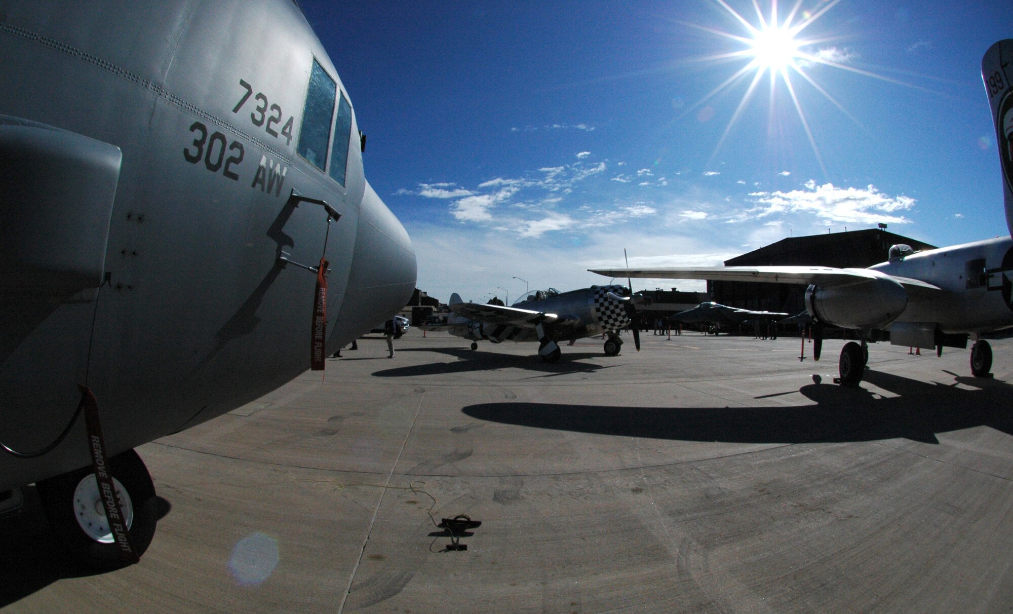 A 302nd Airlift Wing-assigned C-130 gleams in the Colorado morning sun May 19 with two, World War II-era aircraft, including the P-47 Thunderbolt fighter plane (center) and a B-25 Mitchell bomber (right) at Peterson Air Force Base, Colo. The aircraft were joined by an F-15C Eagle, a Colorado Air National Guard F-16 Fighting Falcon and a Canadian CF-18 Hornet as part of a change of command ceremony for the North American Aerospace Defense Command and U.S. Northern Command organizations. The 302nd Airlift Wing is an Air Force Reserve Command-assigned unit. (U.S. Air Force photo/Staff Sgt. Stephen J. Collier)