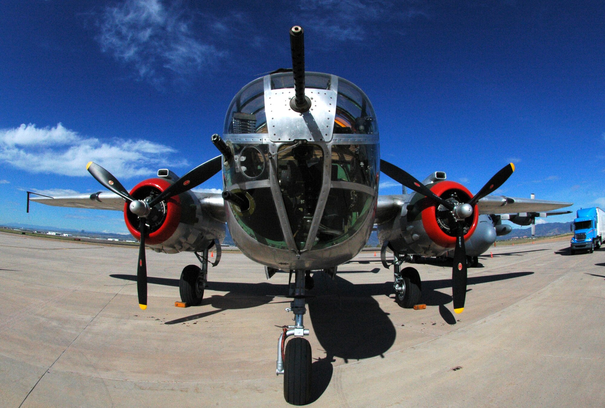 A World War II-era B-25 Mitchell medium bomber stands ready more than 60 years later for a static display aircraft mission May 19 at Peterson Air Force Base, Colo. The bomber was parked next to a 302nd Airlift Wing C-130 Hercules (right) and was joined by a P-47 Thunderbolt, an F-15C Eagle, a Colorado Air National Guard F-16 Fighting Falcon and a Canadian CF-18 Hornet as part of a change of command ceremony for the North American Aerospace Defense Command and U.S. Northern Command organizations. The 302nd Airlift Wing is an Air Force Reserve Command-assigned unit. (U.S. Air Force photo/Staff Sgt. Stephen J. Collier)