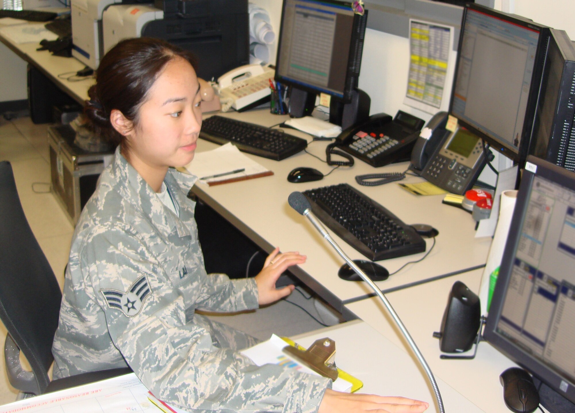 Senior Airman Christina Lai, 22nd Air Refueling Wing command post controller, currently deployed to Southwest Asia responds to an aircrafts communications check May 17, 2010. Airman Lia conducts fallen warrior ceremonies, conducts mass communications and tracks flights in her area of responsibility. She has been stationed at McConnell Air Force Base for three years.