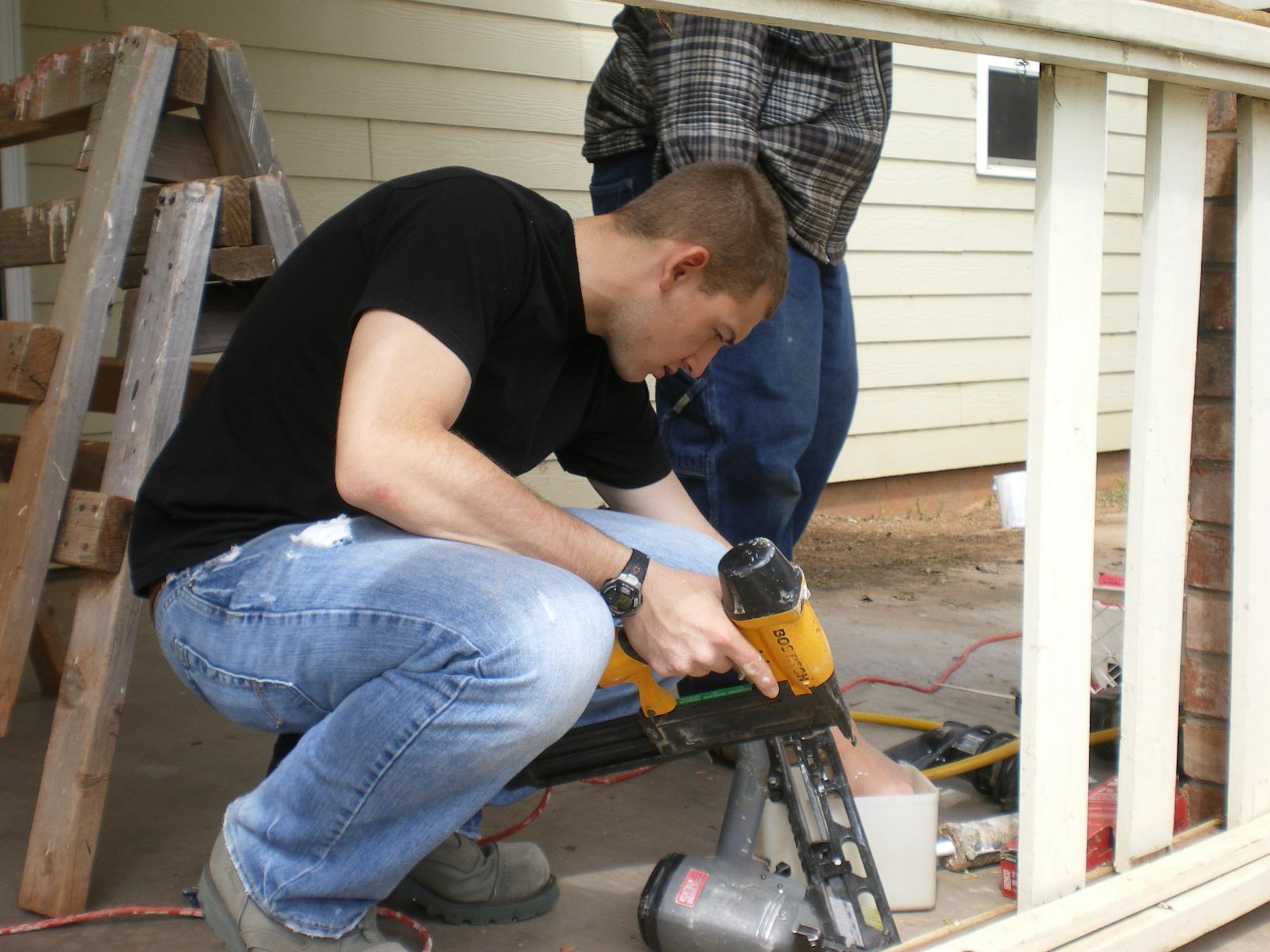 362nd Training Squadron Chapel Rope Airman Joshua DeJongh prepares to help restore a house during a Habitat for Humanity project May 8, 2010 in Wichita Falls, Texas. A 13-Airman team volunteered a day off restoring a house so a mother and her six children could move in.(U.S. Air Force photo Tech. Sgt. Brian Schaaf)