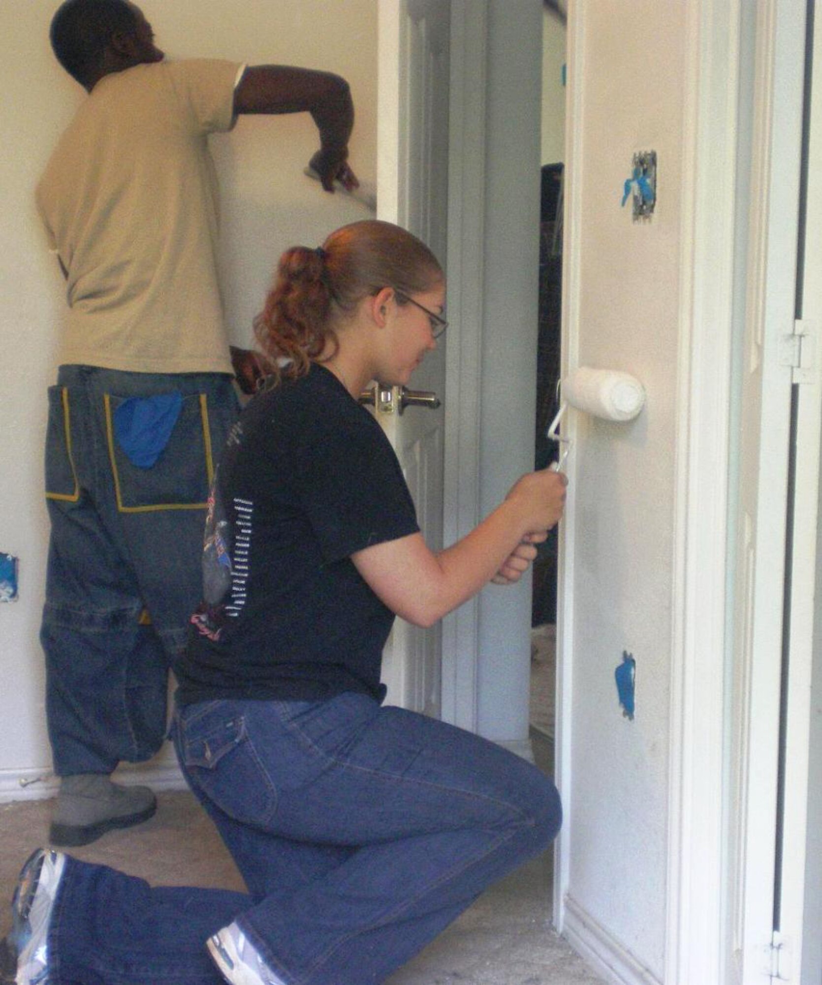 366th Training Squadron Chapel Rope Airman Rakiam Allen (back) paints with Airman Jennifer Starcher(front), 383rd TRS chapel rope, during a Habitat for Humanity volunteer project May 8, 2010, in Wichita Falls, Texas. The 13-Airman team was led by Tech Sgt. Brian Schaaf, 82nd Training Wing Chaplain's Office and Jake McDaniel, 82nd TRW Solid Rock Cafe coordinator. (U.S. Air Force photo Tech. Sgt. Brian Schaaf)