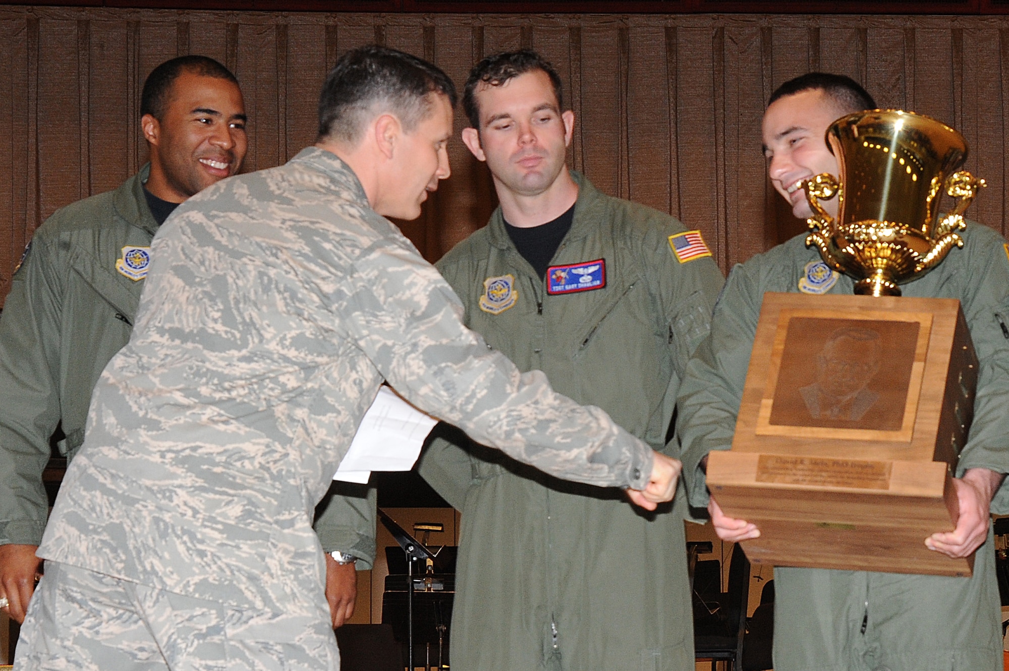 Col. Jamie Crowhurst, 22nd Air Refueling Wing commander, thanks Senior Airman Michael Cerni, 349th Air Refueling Squadron in-flight systems operator boom instructor, as he holds the David R. Mets Trophy while (left) Capt. Robert Barkers, 349th Air Refueling Squadron executive officer, Tech. Sgt. Gary Shamlian, 349th Air Refueling Squadron training flight instructor boom NCOIC, look on during the Wichita River Festival military recognition ceremony, May 15, 2010, held at Century II in downtown Wichita, Kan.  Captain Barkers and Sergeant Shamlian were awarded the trophy for their outstanding leadership, which resulted in the 349th ARS raising more than $16,000 during the Bowl For Kids’ Sake 2009 Campaign for the Big Brothers Big Sisters program.  McConnell Air Force Base is one of Wichita’s leading Big Brothers Big Sisters supporter and one of its 2009 top five national supporters. (U.S. Air Force photo/Tech. Sgt. Chyrece Campbell)
